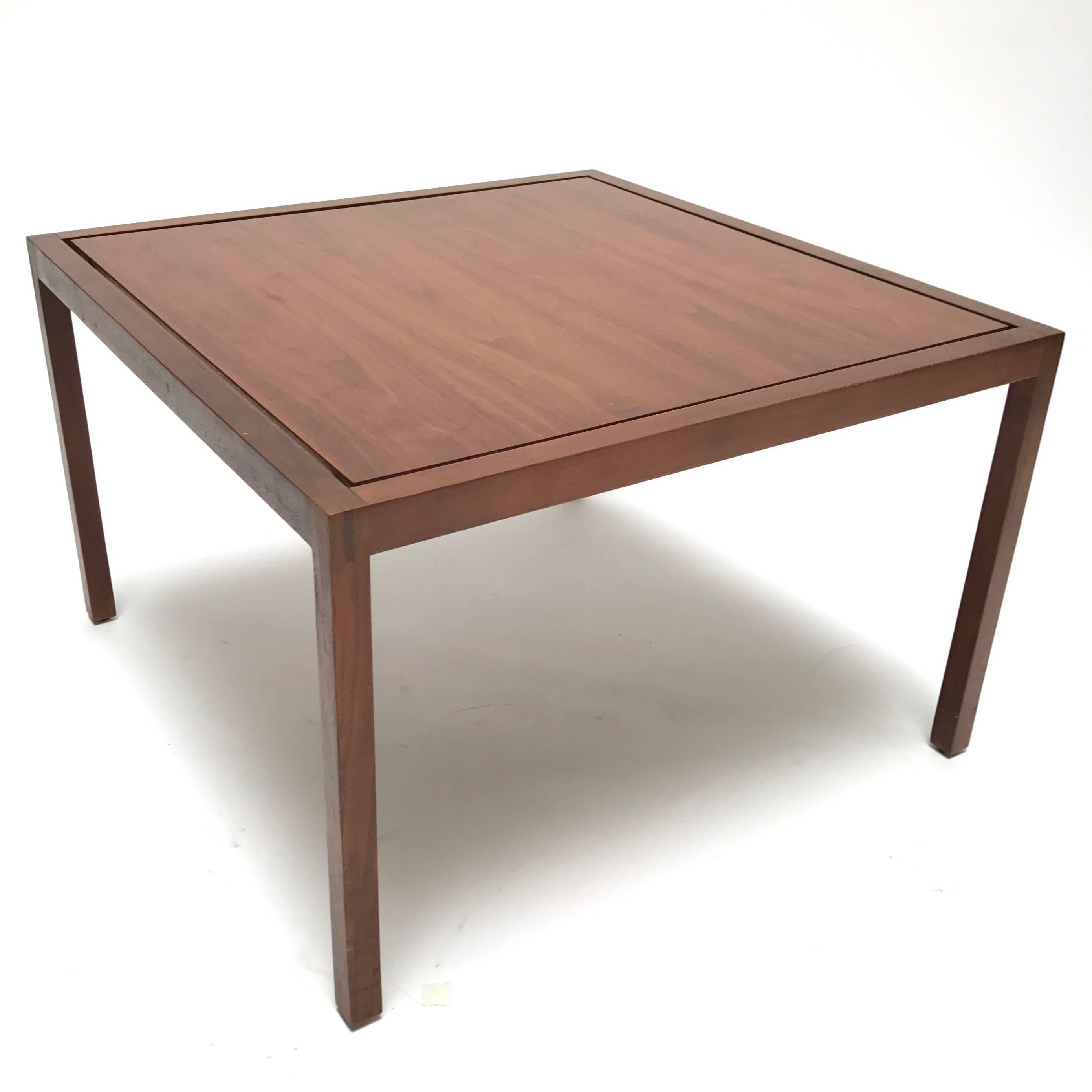 An early Mid-Century Modern square walnut side or cocktail table by Lewis Butler for Knoll International.

Clean, timeless lines feature a sharply bevelled floating top jewel-set within a finely crafted finger joint frame. Equally at home in a