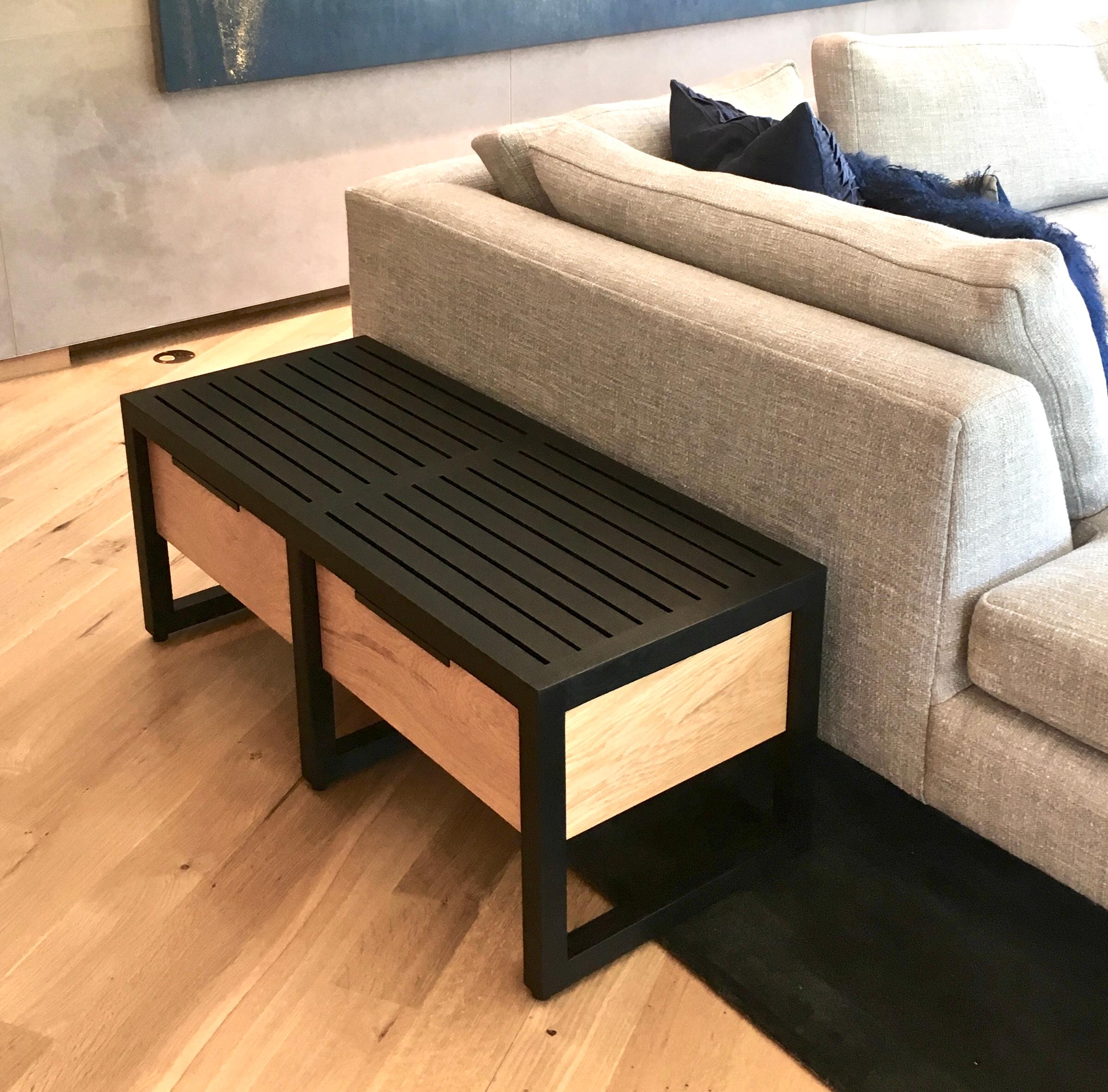New York Heartwoods' Lewis bench adds elegant storage to midcentury-style design. The unique black veining of spalted maple wraps around the contiguous panels and drawer fronts, complimenting the ebonized oak frame. Each bench is made by hand using