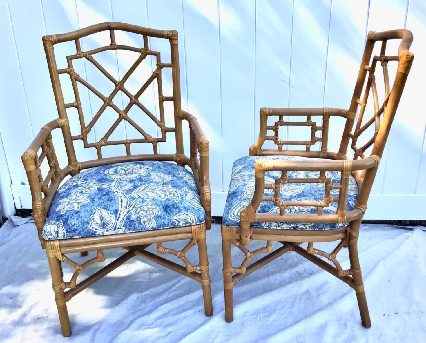 An exceptional pair of bamboo rattan dining armchairs by Lexington. The rattan frames have a Chinese Chippendale look. Reinforced with leather rawhide strapping on all exposed frame joints. The chairs have excellent joinery and craftsmanship. Each