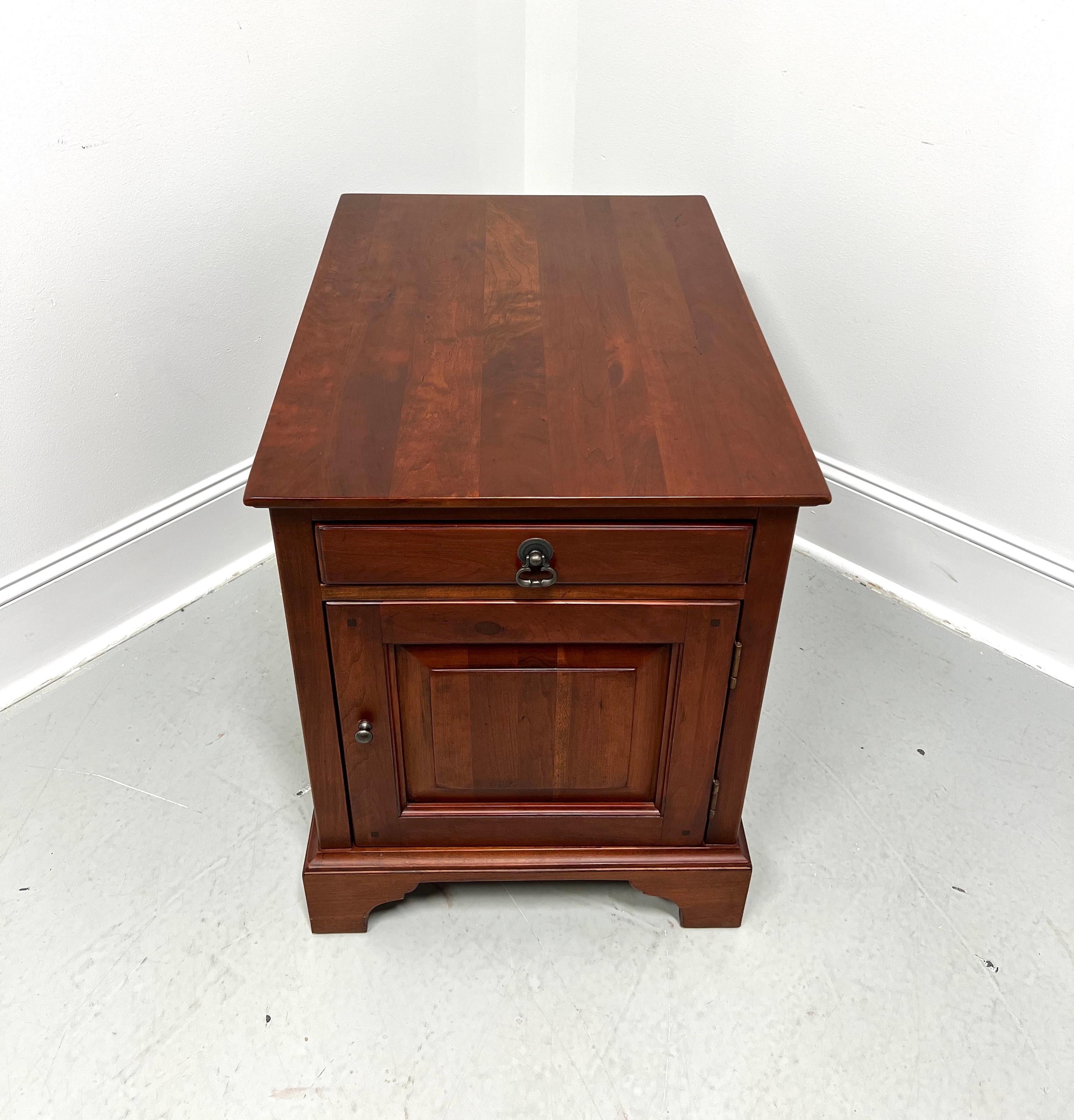 An Arts & Crafts style cabinet accent table by Lexington Furniture, from their Bob Timberlake Collection. Solid cherry wood with brass hardware, miter edge to the top, finished on all sides, bevel edge to the base, and bracket feet. Features one