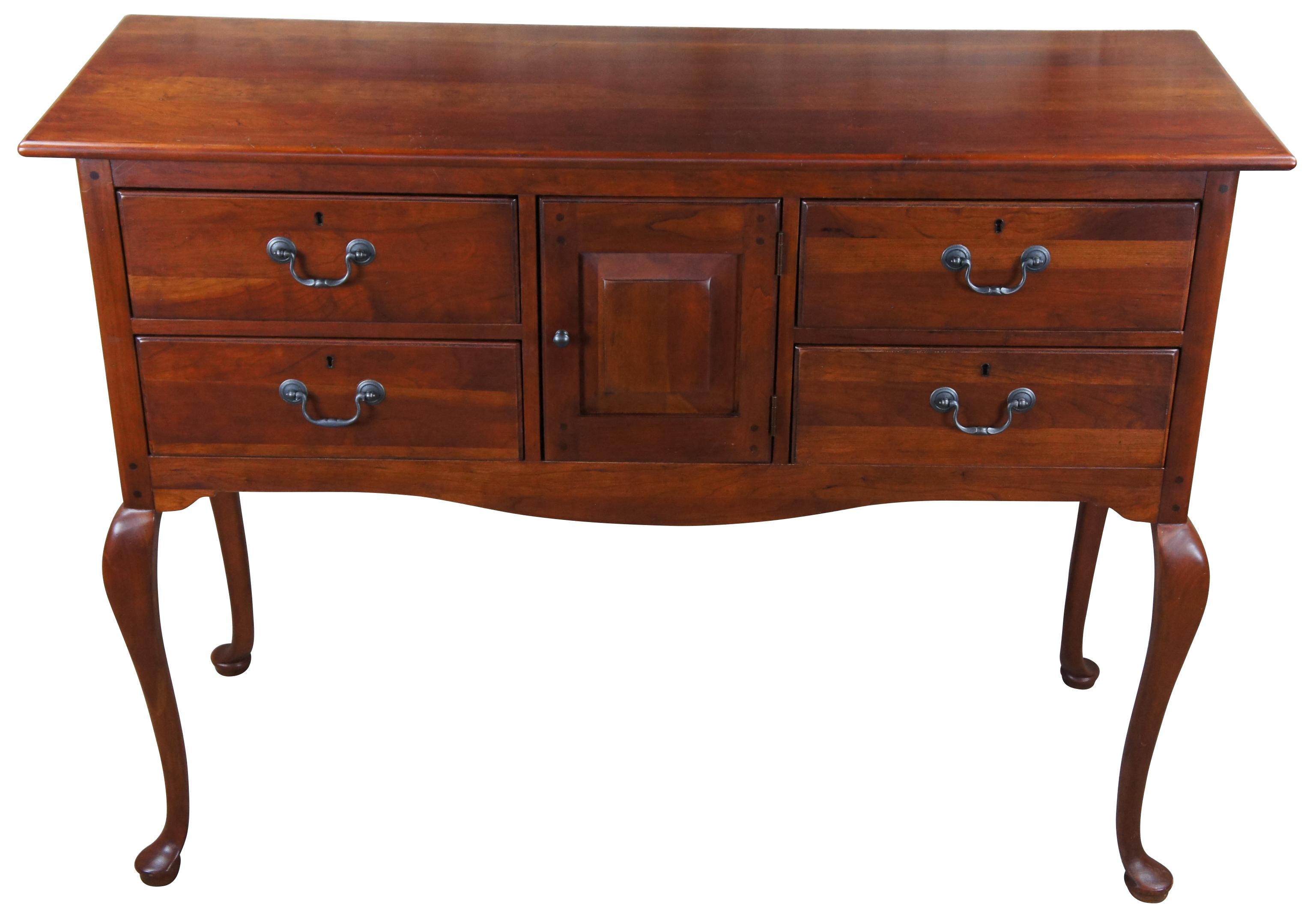 An elegant solid cherry sideboard, server or buffet. by Bob Timberlake for Lexington, circa 1980s. American made farmhouse styling. Features a rectangular frame with central cabinet flanked by four dovetailed drawers. Frame is supported by long