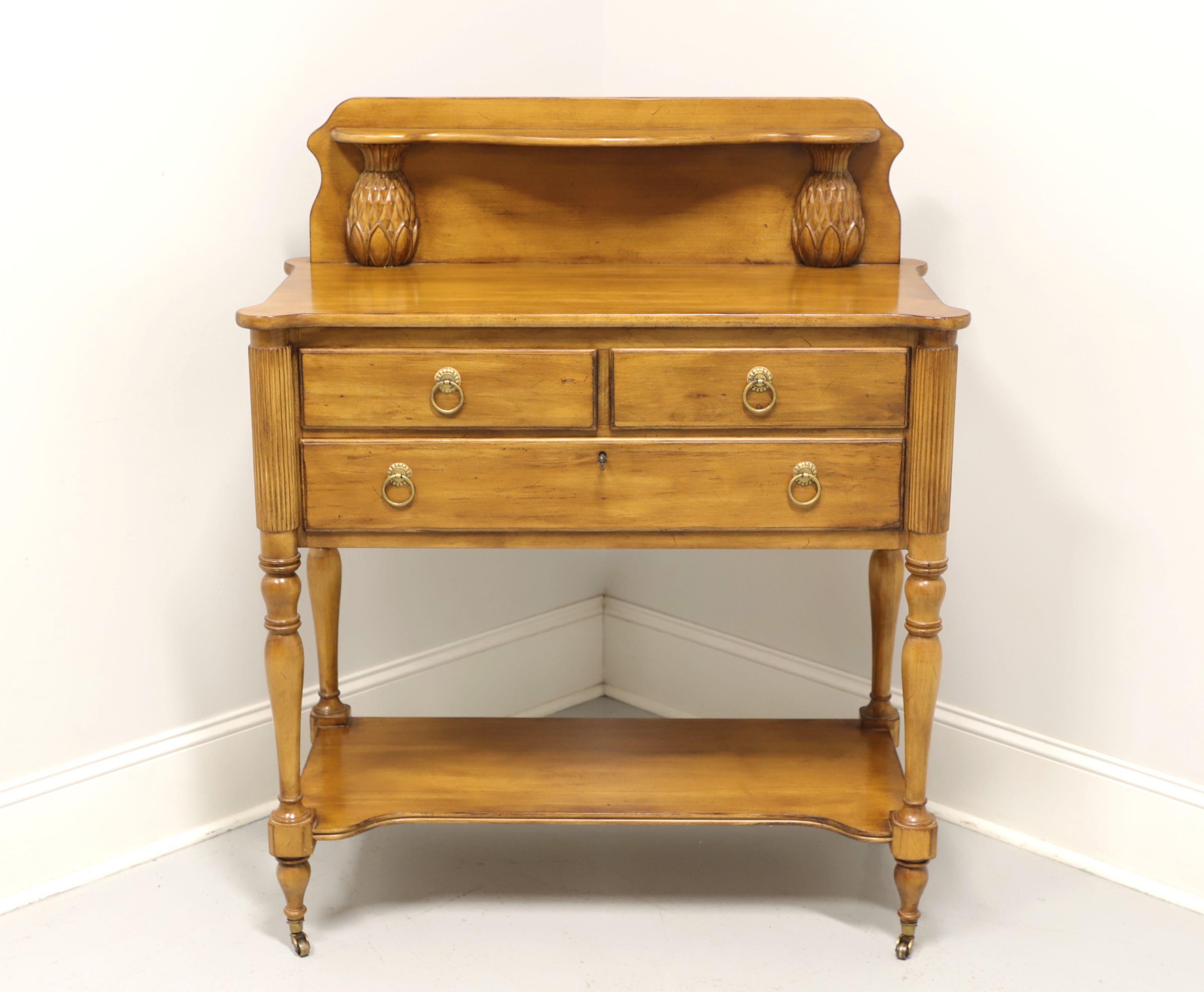 A French Country style server by Lexington, from their The Southern Living Collection. Fruitwood with brass hardware, upper gallery with carved pineapples supporting small shelf, rounded corners, undertier shelf, fluted and turned legs with brass
