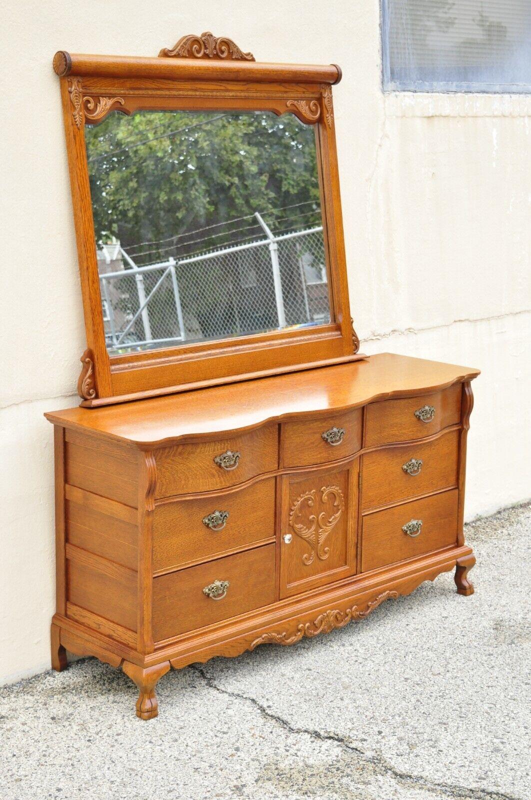 Lexington Victorian sampler oak triple dresser with mirror. Item features paw feet, beautiful wood grain, nicely carved details, 1 swing door, original stamp, 7 dovetailed drawers, quality American craftsmanship, great style and form. Circa Late