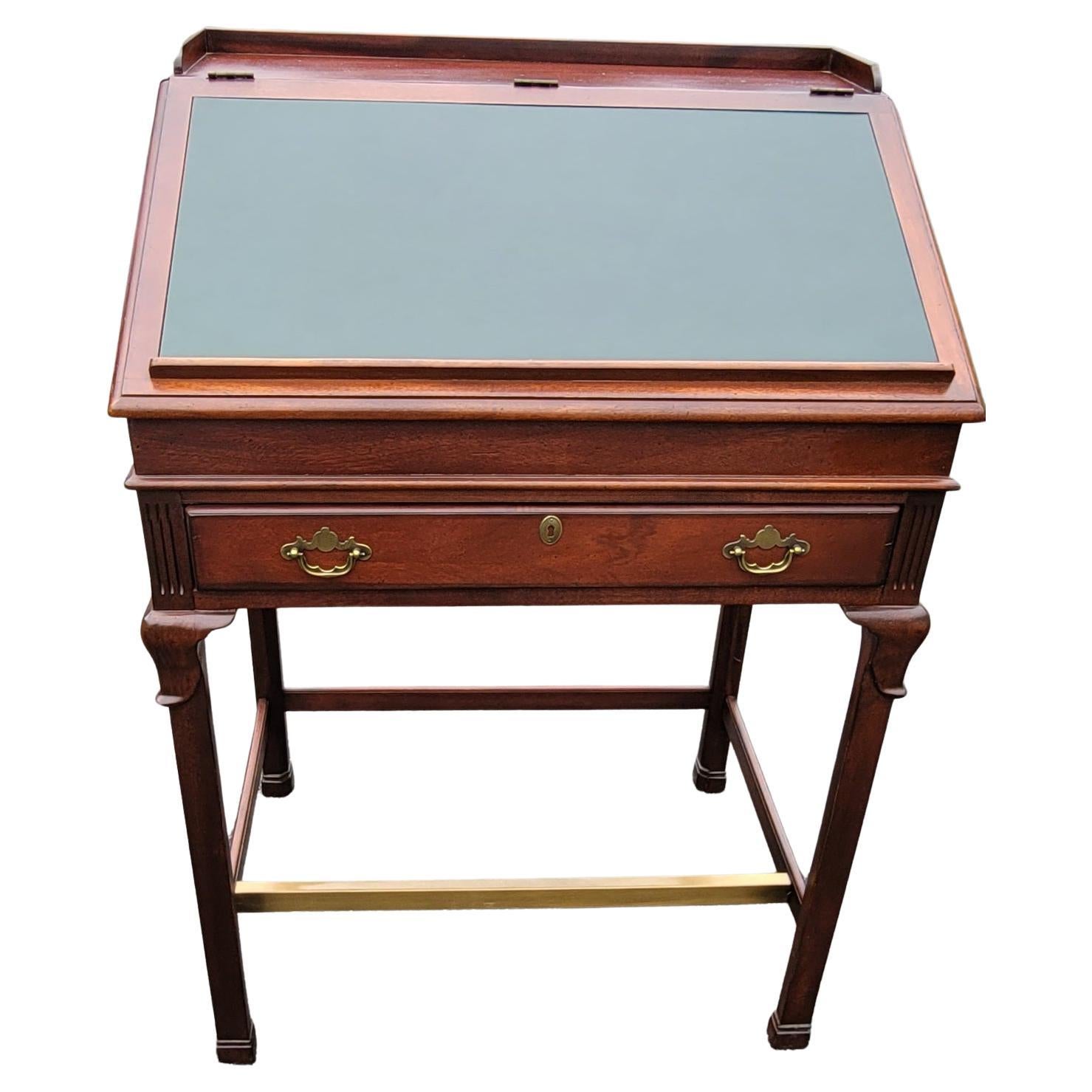 A very rare, limited edition Lexington Furniture's Palmer Home Collection Mahogany  and Tooled Leather  Slant Top Drafting Desk, drafting table with brass feet support and pull-out trays. Large storage drawer with two brass drop pulls. Dark green