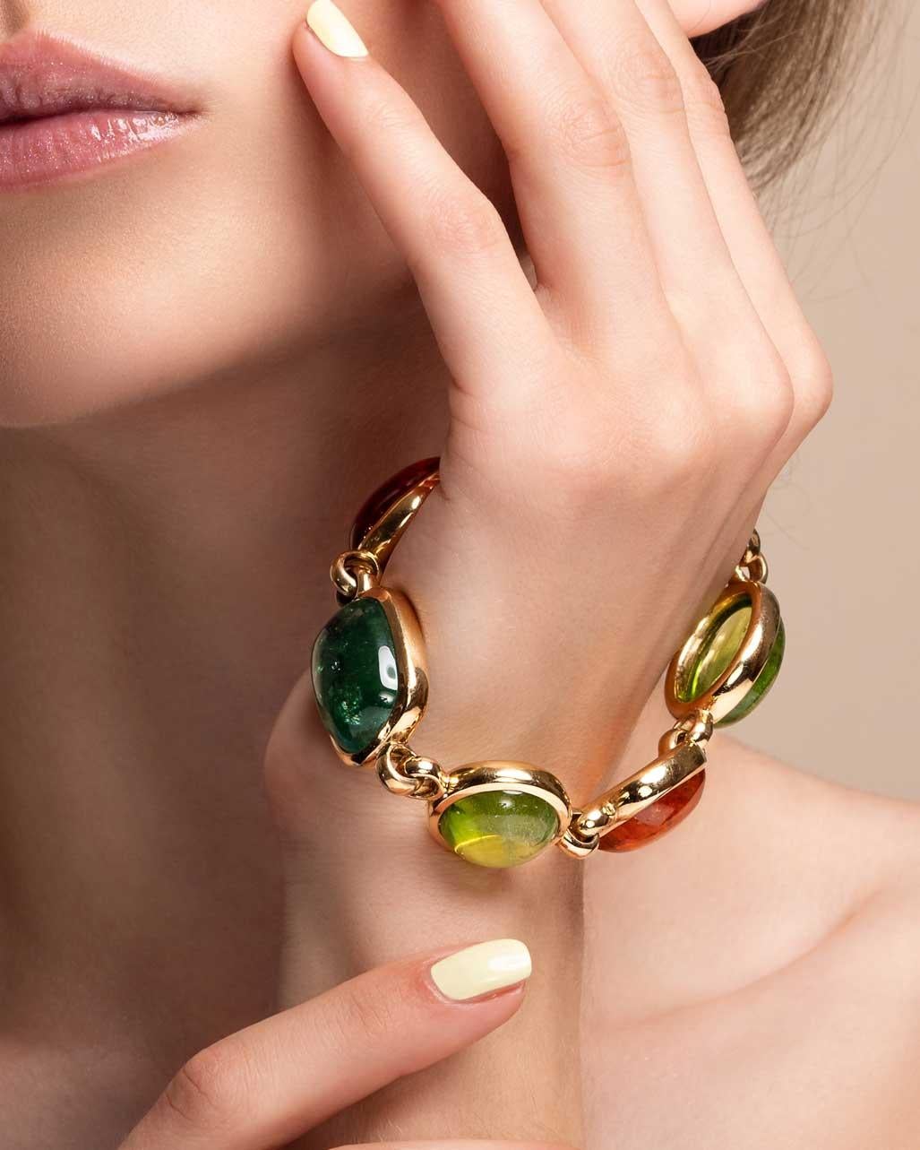 Thomas Leyser is renowned for his contemporary jewellery designs utilizing fine gemstones. 

This 18k rose gold (72.95g) bracelet is set with 6x fine Mandarin Garnet (57.74ct), Green Tourmaline (25.97ct) and Peridot (68.34ct) cabochons.
