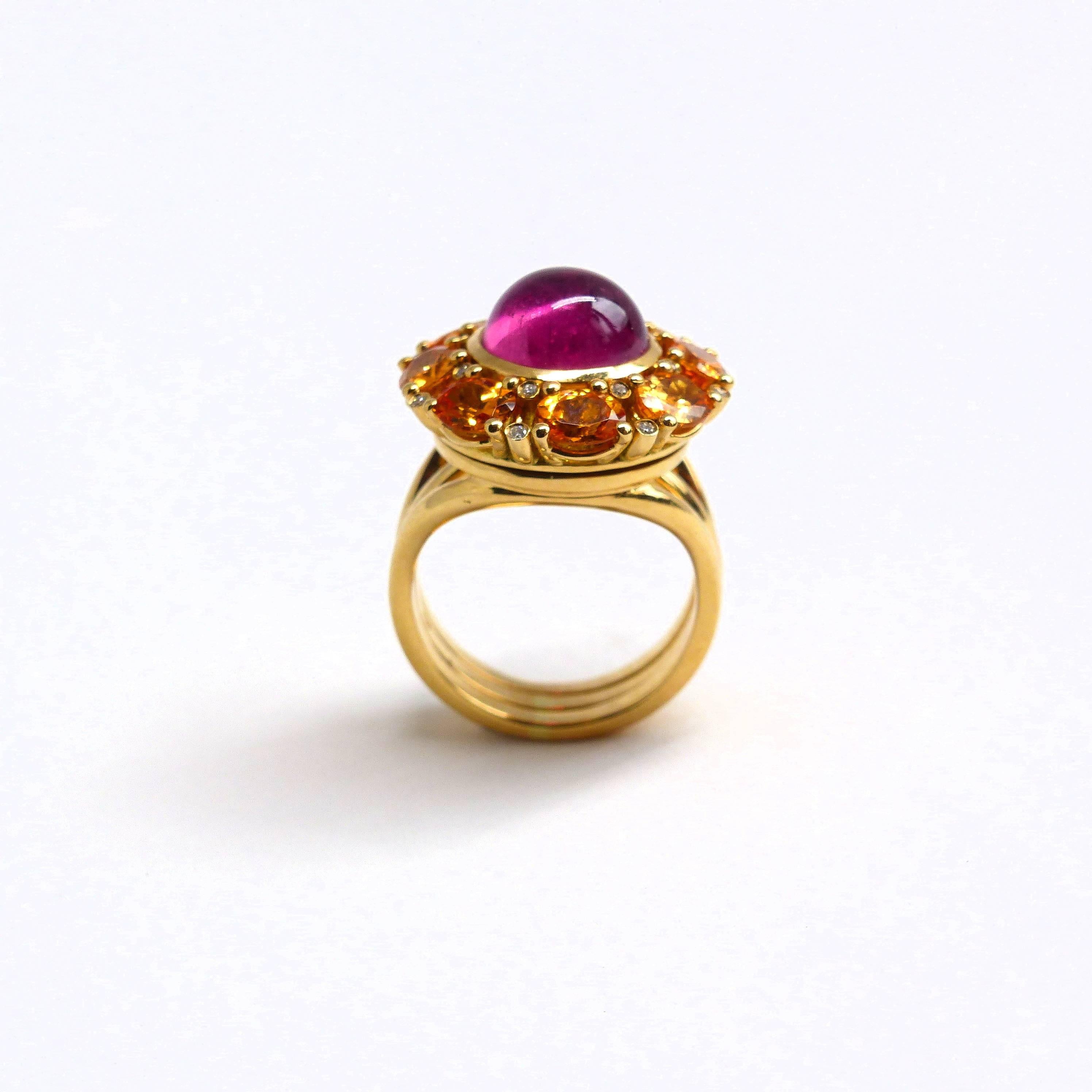 This exquisite 18k Rose Gold ring (19.38g) features:

- 1 Rubellite Cabochon (round, 10mm, 4.60ct)
- 8 faceted Mandarin Garnets (oval, 5x4mm, 3.52ct)
- 16 brilliant-cut Diamonds (1mm, G/VS, 0.12ct).

Ring size: 6.5 (54).

The unique design includes