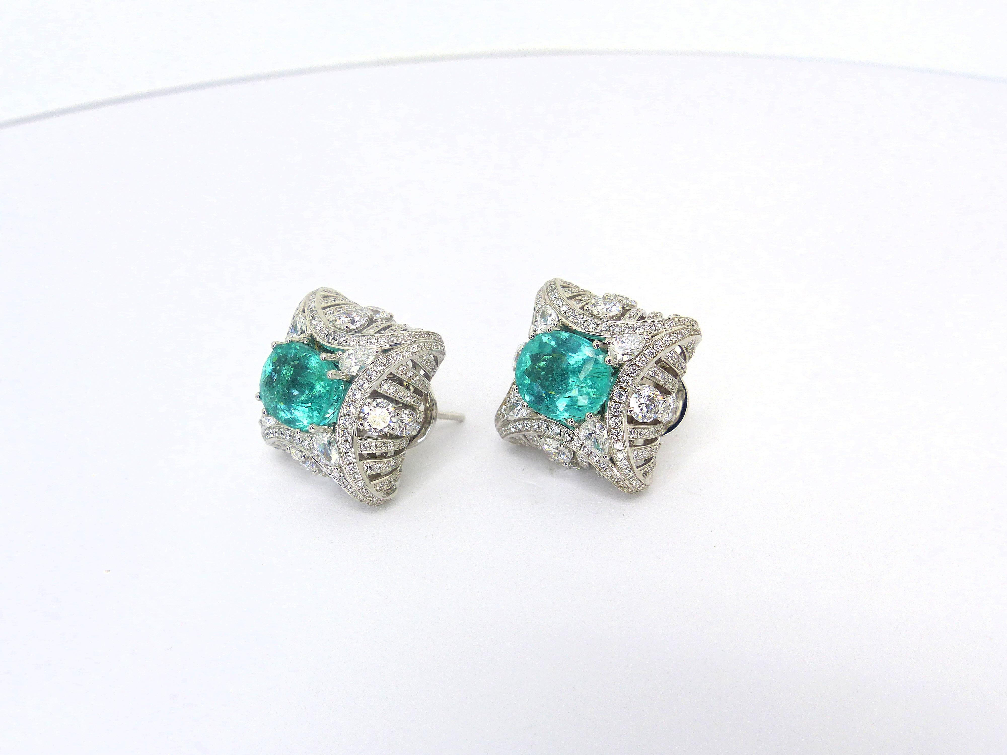 This 750/White Gold Earrings are set with 2 fine Paraiba Tourmaline fac. oval 9,5x7,8mm + Diamonds in various shapes, 4,43cts. D/VS. With clips and studs.

Paraiba Tourmalines are very popular and rare gemstones. The color is electric neon