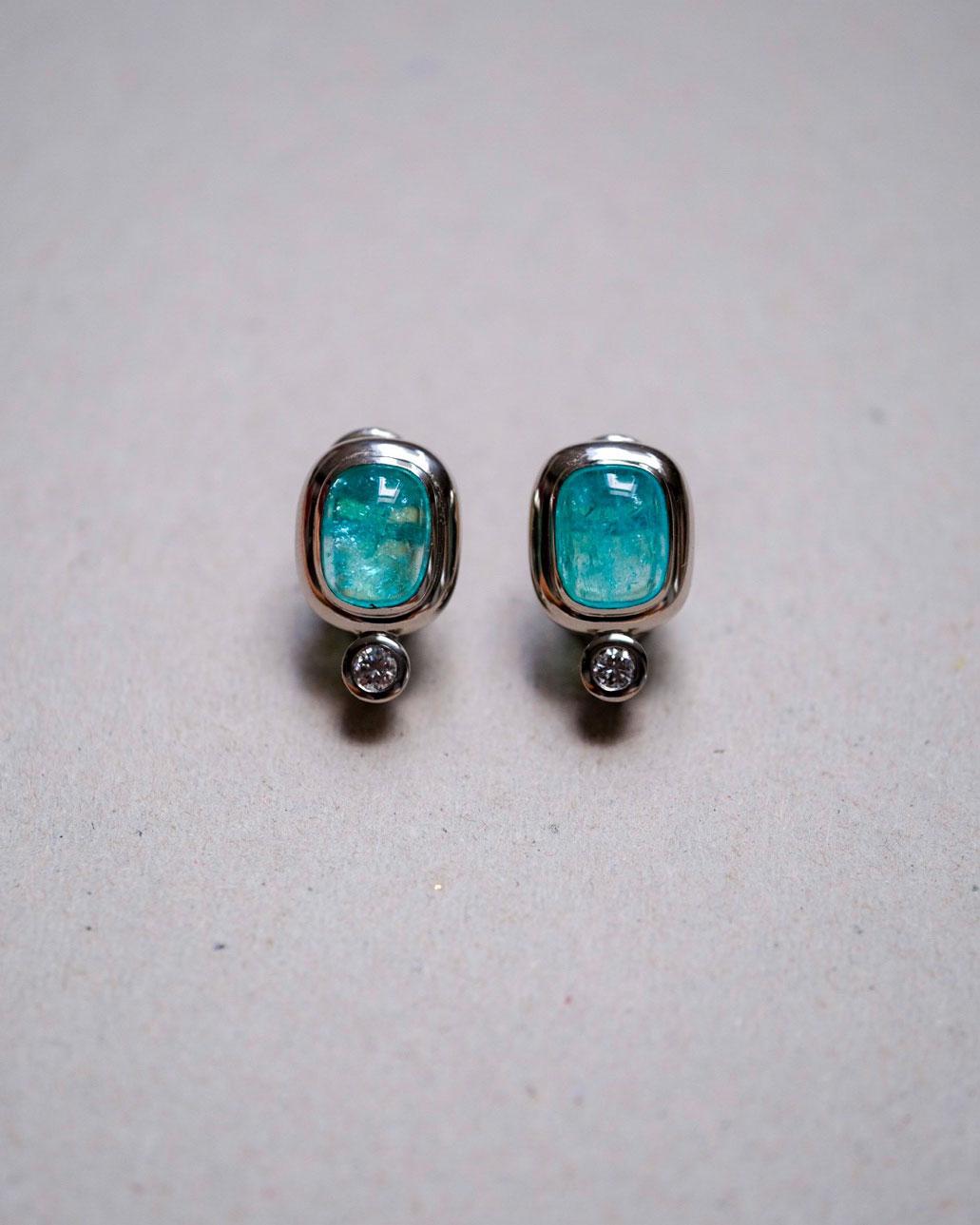 These 950/ Platinum (18.5g) Pair of Earrings are set with 2x fine Paraiba Tourmalines (cushion shap, 10.5x8.5mm) + 2x Diamonds (Brilliant-cut, D/VS, round, 3.5mm, 0.27cts).

Paraiba Tourmalines are very popular and rare gemstones. The color is