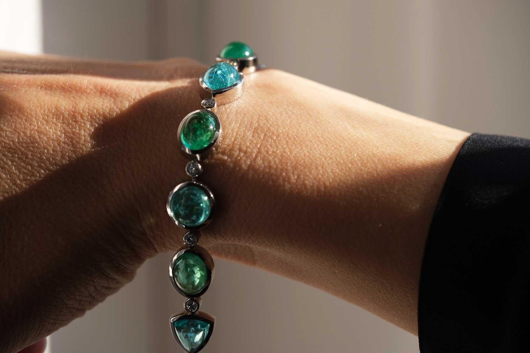 Contemporary Bracelet in Platinum with 11 Paraiba Tourmaline Cabouchons and 80 Diamonds. For Sale