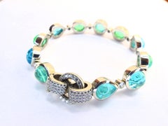 Bracelet in Platinum with 11 Paraiba Tourmaline Cabouchons and 80 Diamonds.