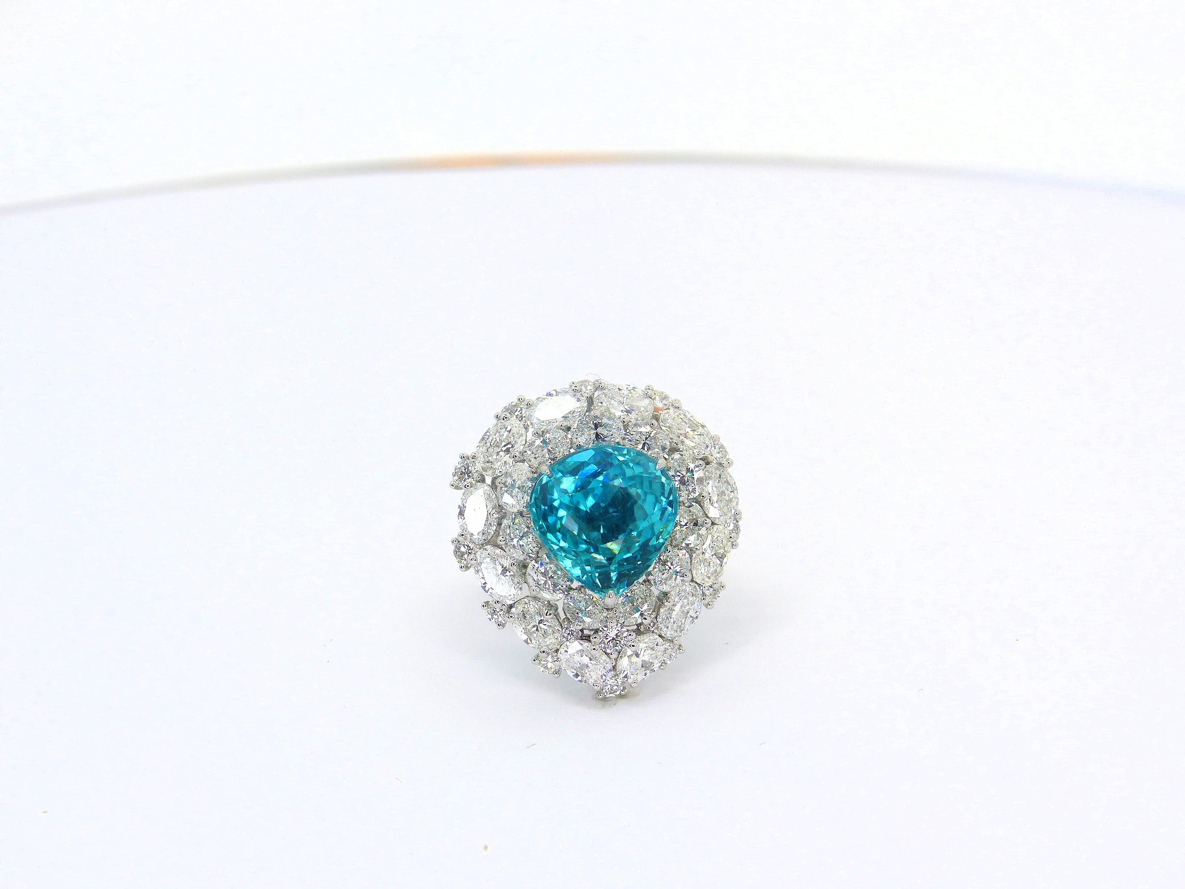 This 950/ Platinum (17,58gr.) Ring is set with 1 top quality Paraiba Tourmaline, Pearshape 12,1x11,7mm, 8,01cts. + Diamonds 5,74cts., D/VS various shapes.

Paraiba Tourmalines are very popular and rare gemstones. The color is electric neon