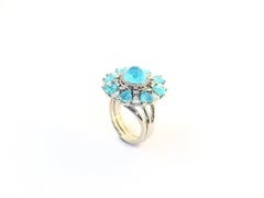 Ring in Platinum with 1 green Paraiba Tourmaline Cabouchon and 8 Paraibas fac.