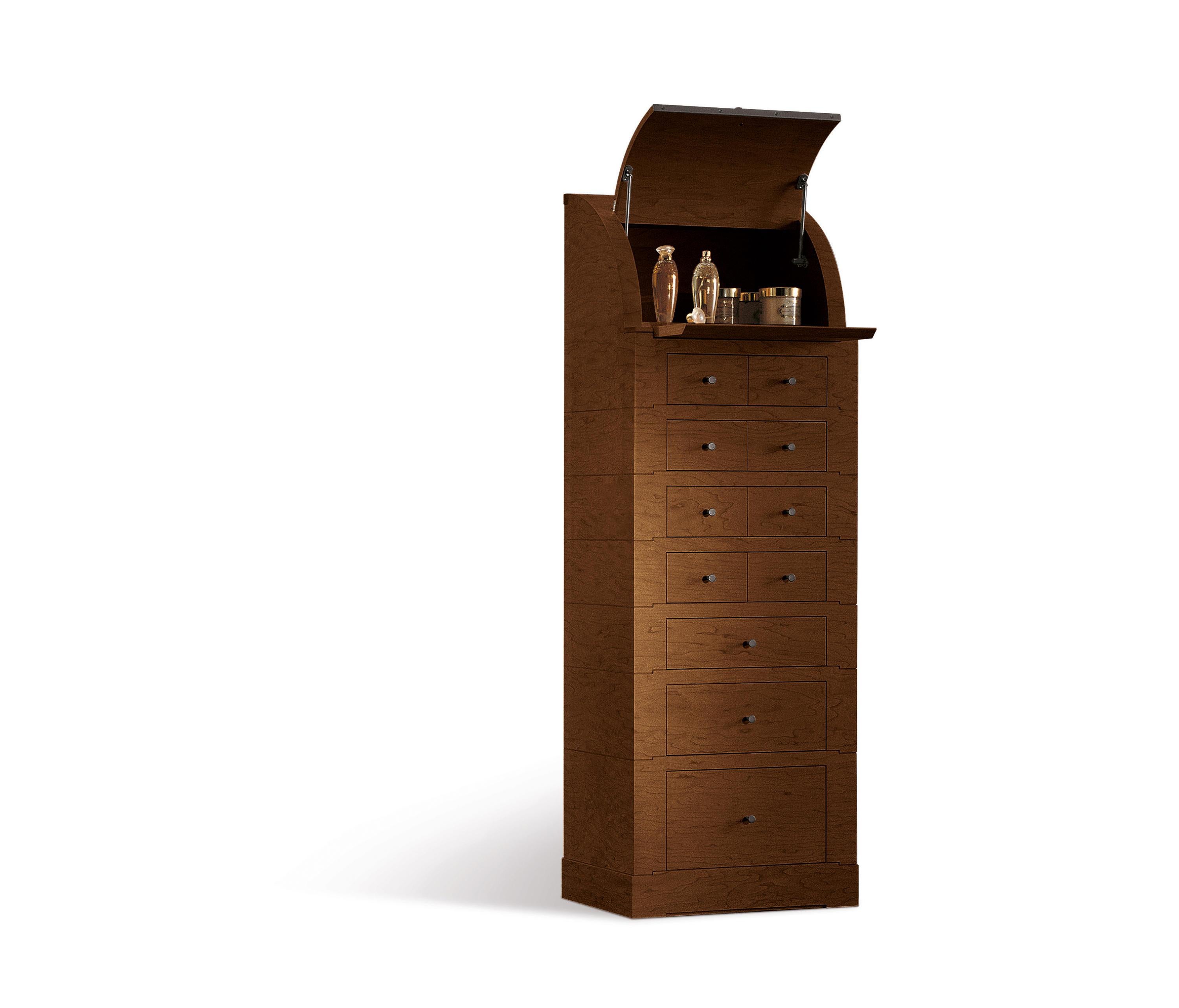 Tall chest of drawers with the plywood frame in walnut Canaletto wood veneer. It is equipped with eleven drawers, an upper compartment with a flap door and a removable shelf. The handles are in metal painted in a bronze color.
A chest of drawers