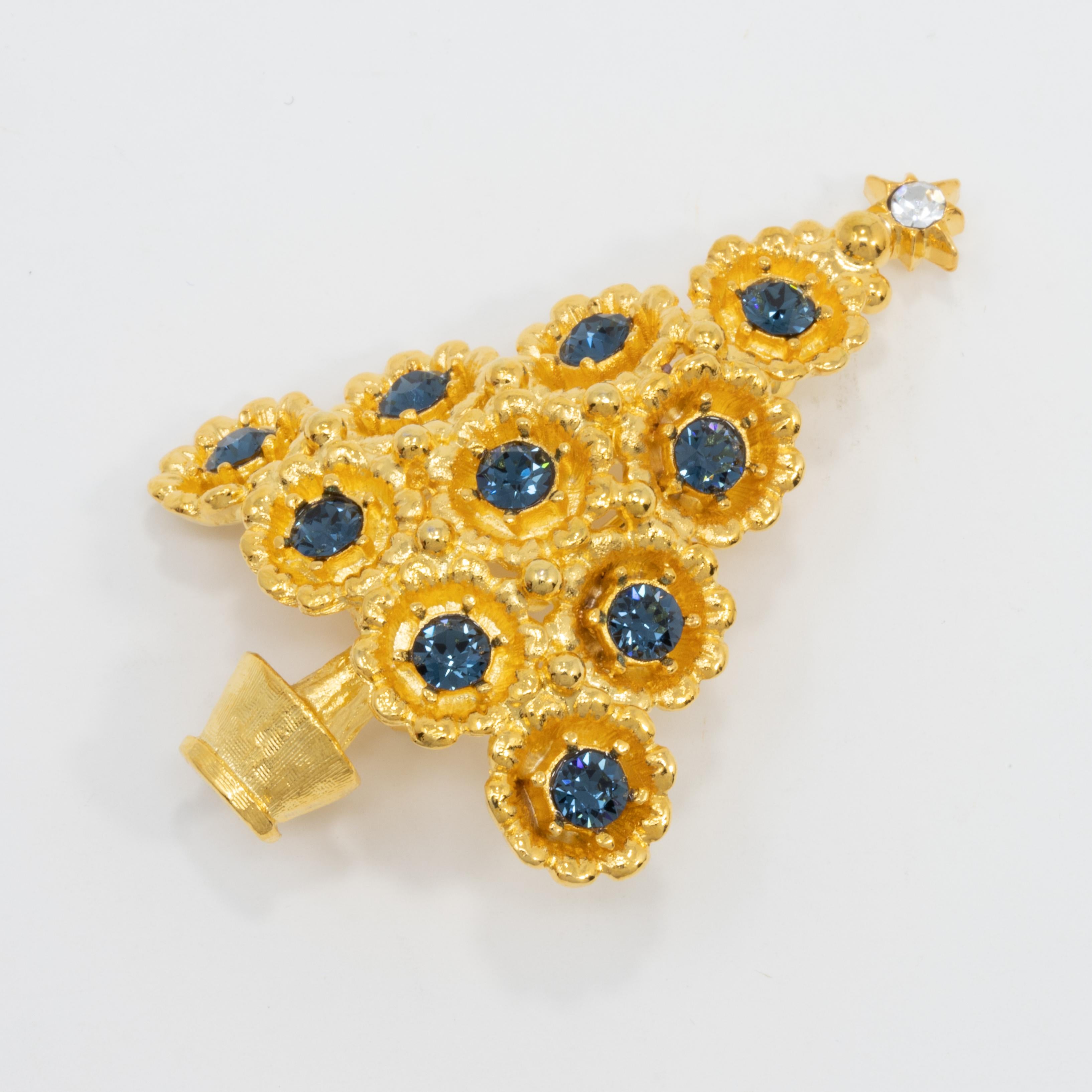 Festive golden pin perfect for any holiday or winter occasion. This Christmas tree is decorated with blue sapphire crystals.

Tags / marks / hallmarks: LIA

Vintage, never-worn piece. Like-new and wonderfully preserved.