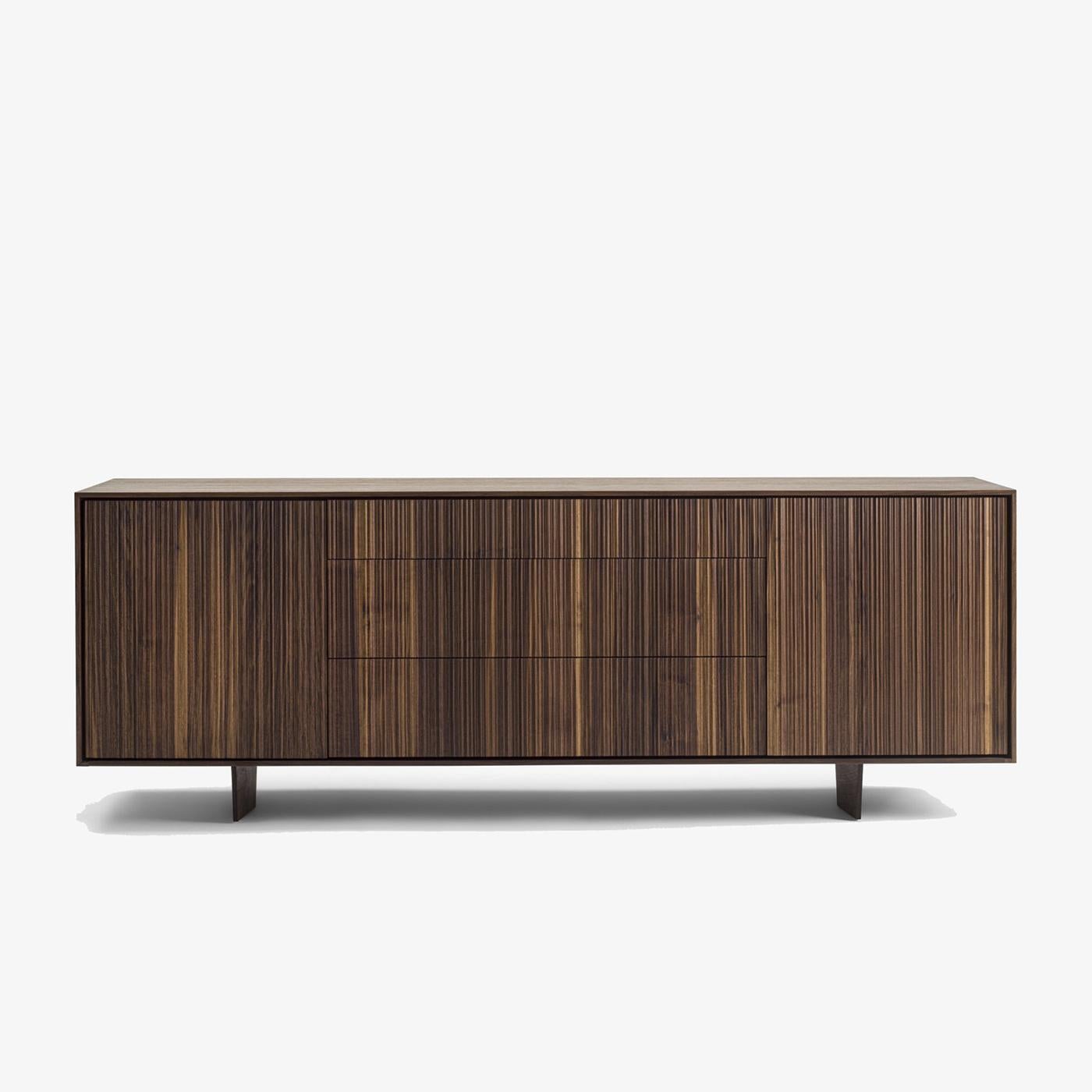 Sideboard Liama with solid walnut wood structure with vertical 
lines on front parts, with 2 doors and with 3 drawers with dovetail 
joints and with easy glide system.
 