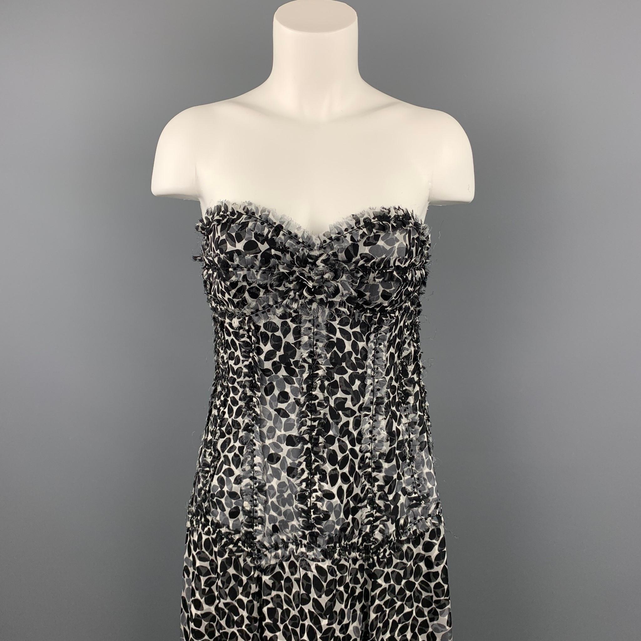 LIANCARLO gown comes in a black & white chiffon silk with a slip liner featuring a strapless style, sequined details, slit design, a-line skirt, and a side zipper closure. Made in USA.

Very Good Pre-Owned Condition.
Marked:

Measurements:

Bust: 30