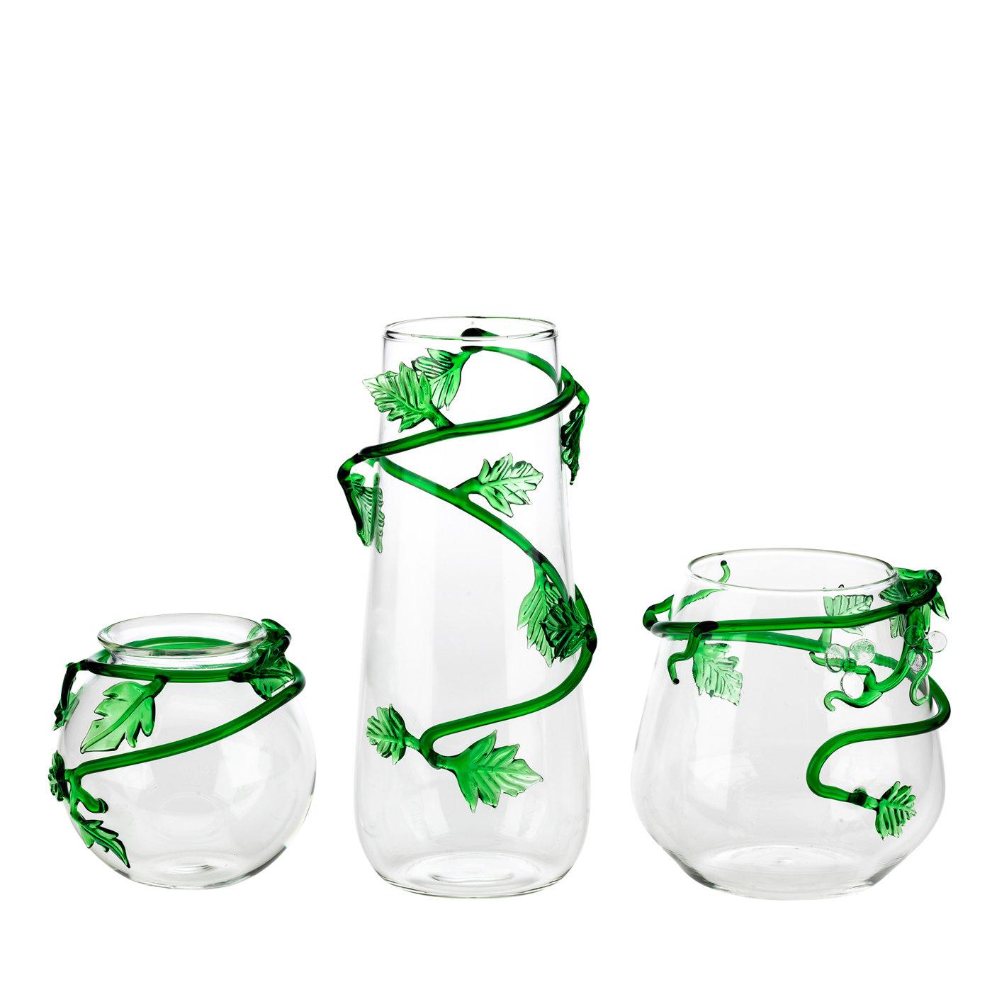 Part of the Tropical Collection, this elegant and vibrant mouth-blown glass vase is a striking addition to any room. The tapered silhouette narrows towards the rim (⌀ 8 cm), enlivened by a green liane with large leaves gracefully enveloping the