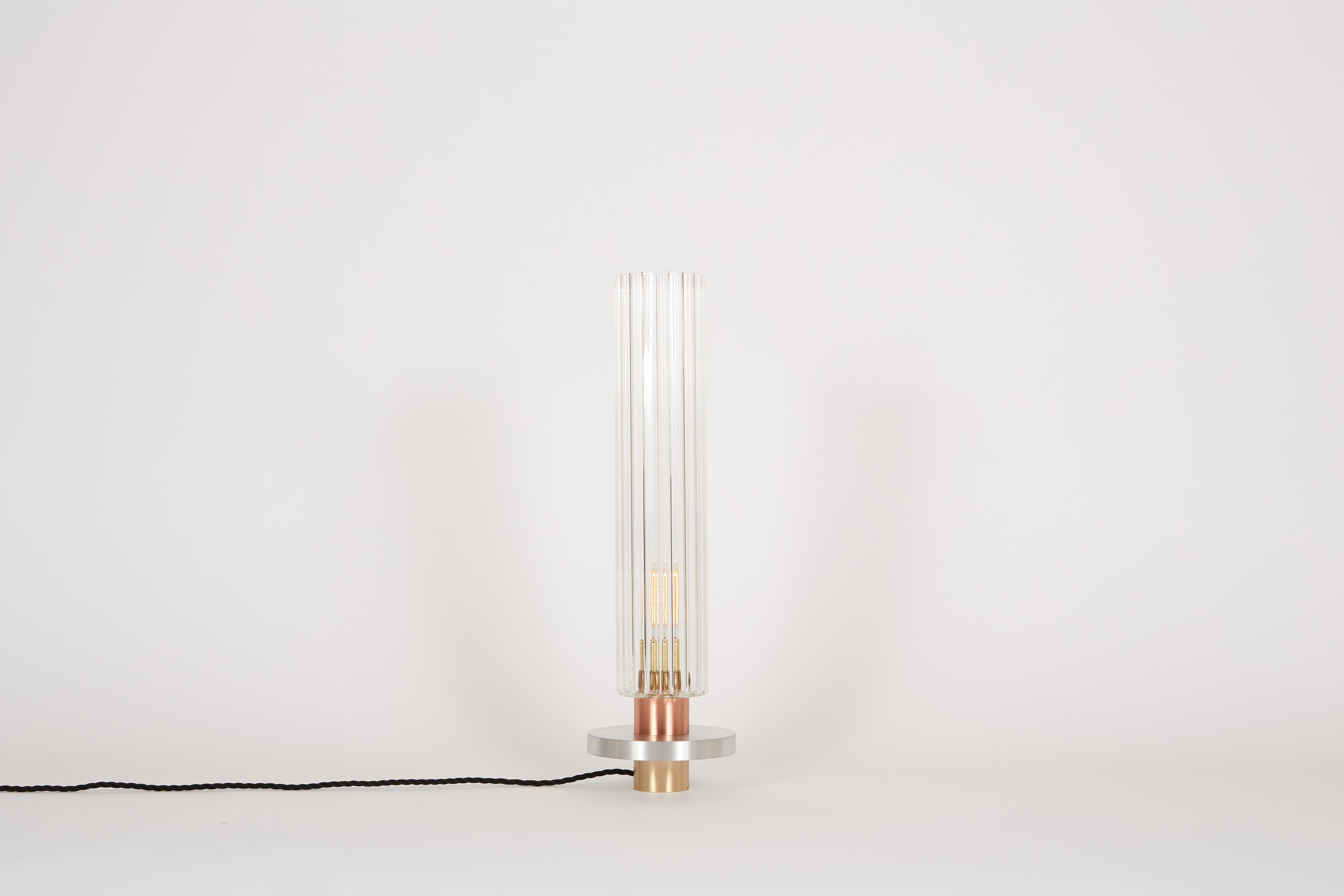 The Liban lamp is a statement piece that does not impose itself. Its unusual proportions, the refinement of the brass make it a day sculpture. The light is diffused and crystalline. The worked glass is both light and subtle.

Table lamp -
