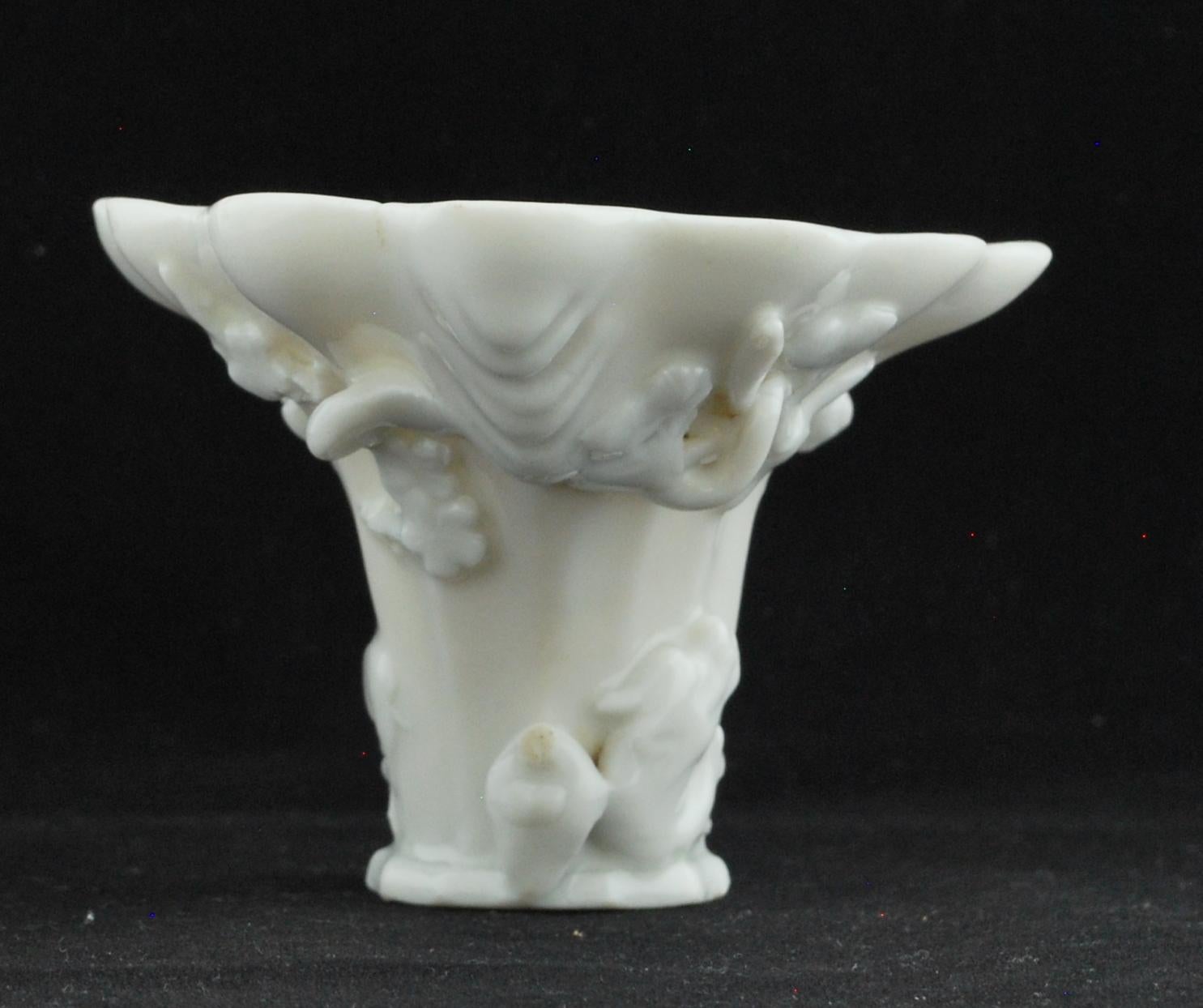 A rather good libation cup, in Dehua’s luscious porcelain. The form is based on the Rhinoceros horn, with applied decoration.