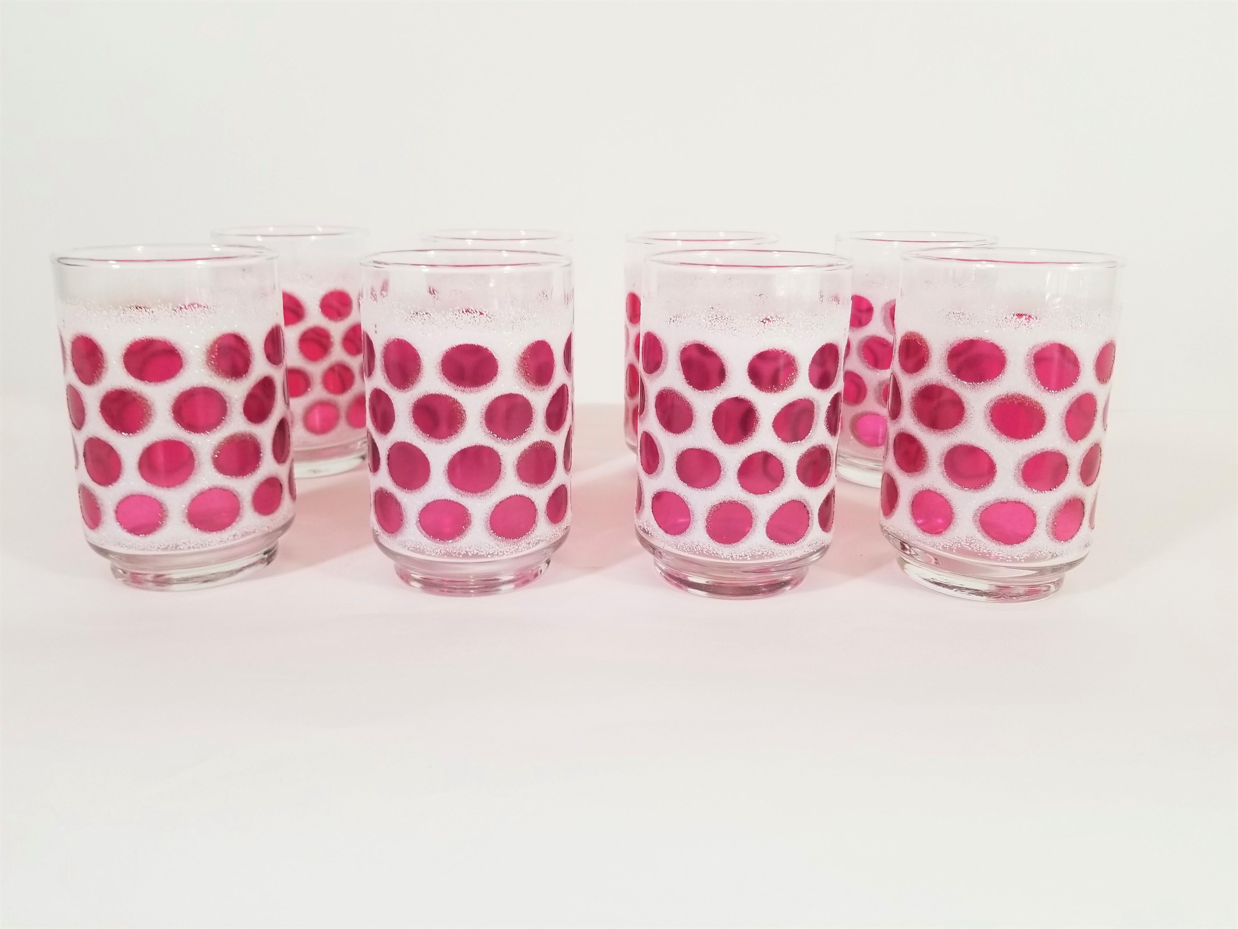 Set of 8 midcentury glasses made by Libbey. A fun set with dark pink / reddish blown glass dots surrounded by a textured white frosting. All glasses are in excellent condition and marked with Libbey signature L on bottom.