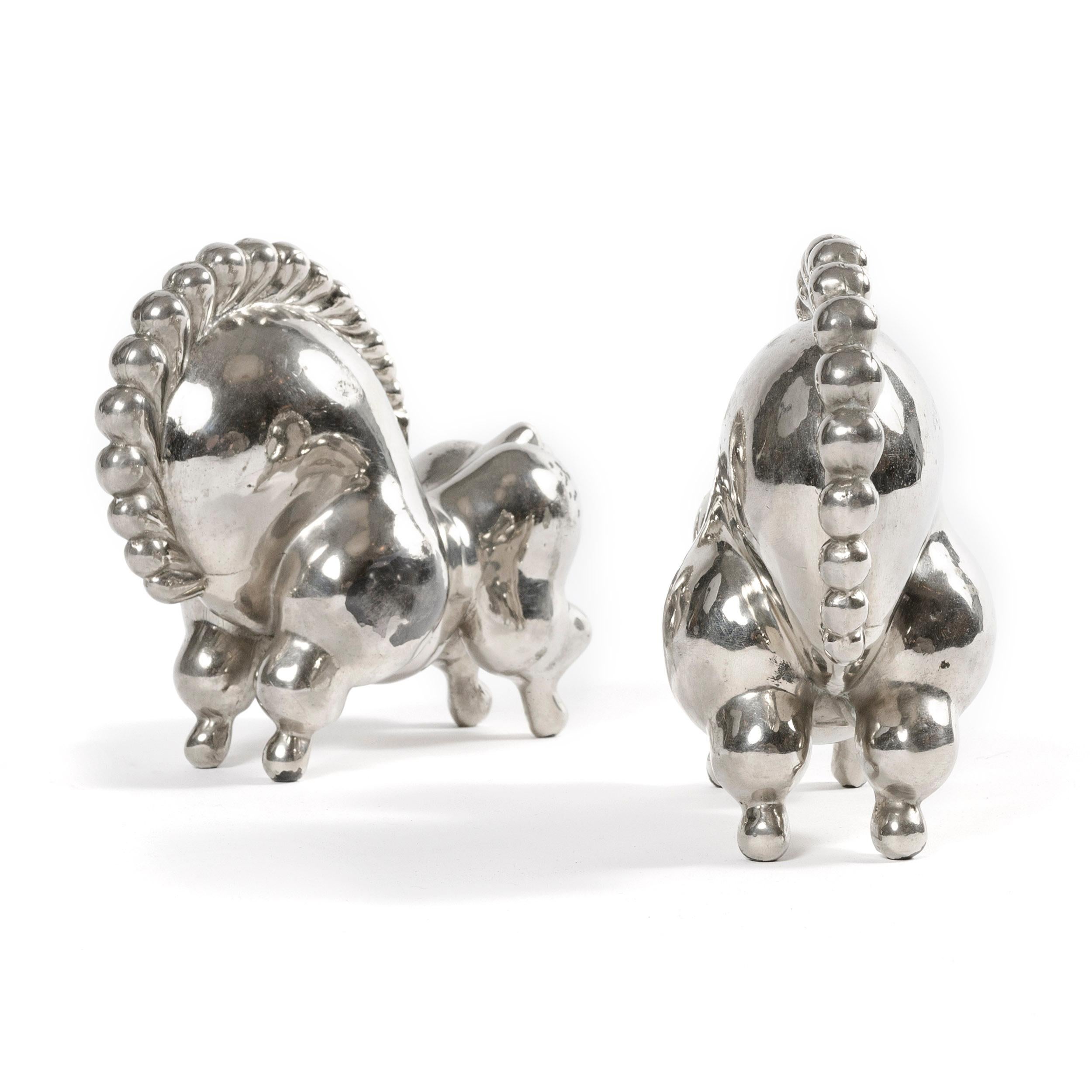 An early pair of nickel-plated, fanciful 'Libbiloo' circus horse bookends by Russel Wright. Marked RW.