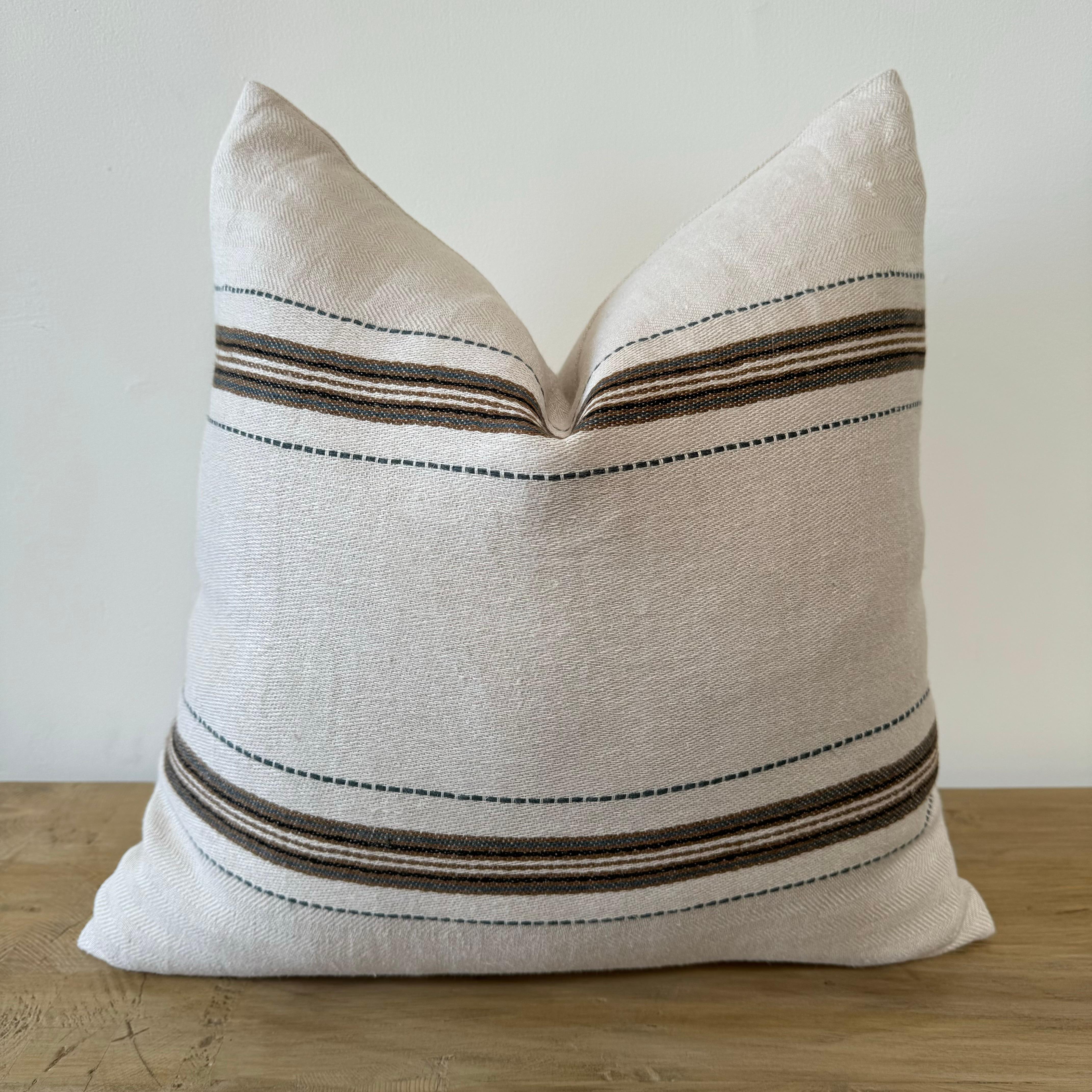 The Tinos pillow features an elevated neutral palette, highlighted by a beautiful slate blue/green. They make a warm addition to any living or bedroom, and have great mix and match versatility. 
Made of 100% Belgian linen they will only get better