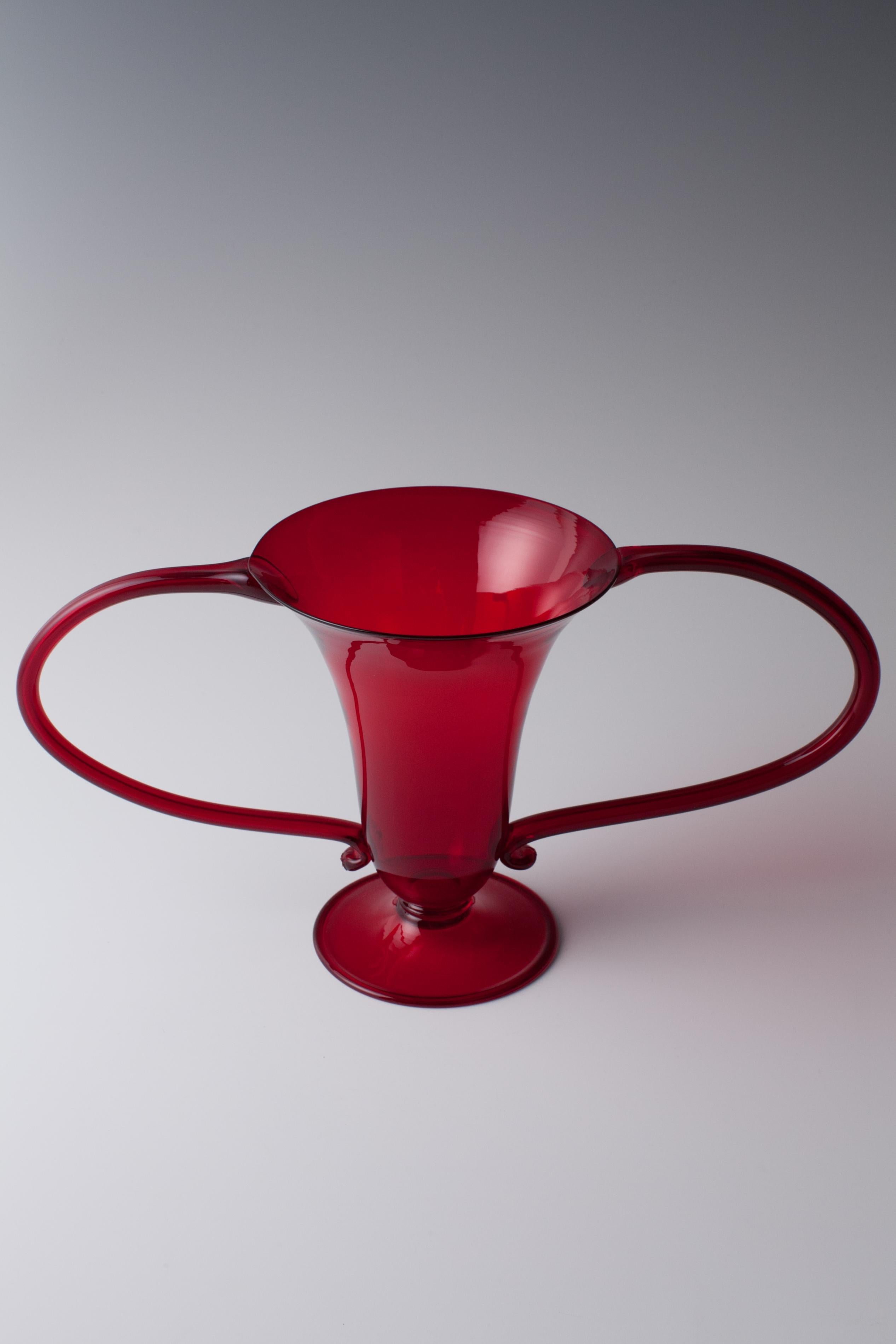 The design is from 1923 by Vittorio Zecchin for Venini

Designed by Vittorio Zecchin for Venini in 1923

Dark-red glass made by hand and mouth blown.

Signed / Marked: No.