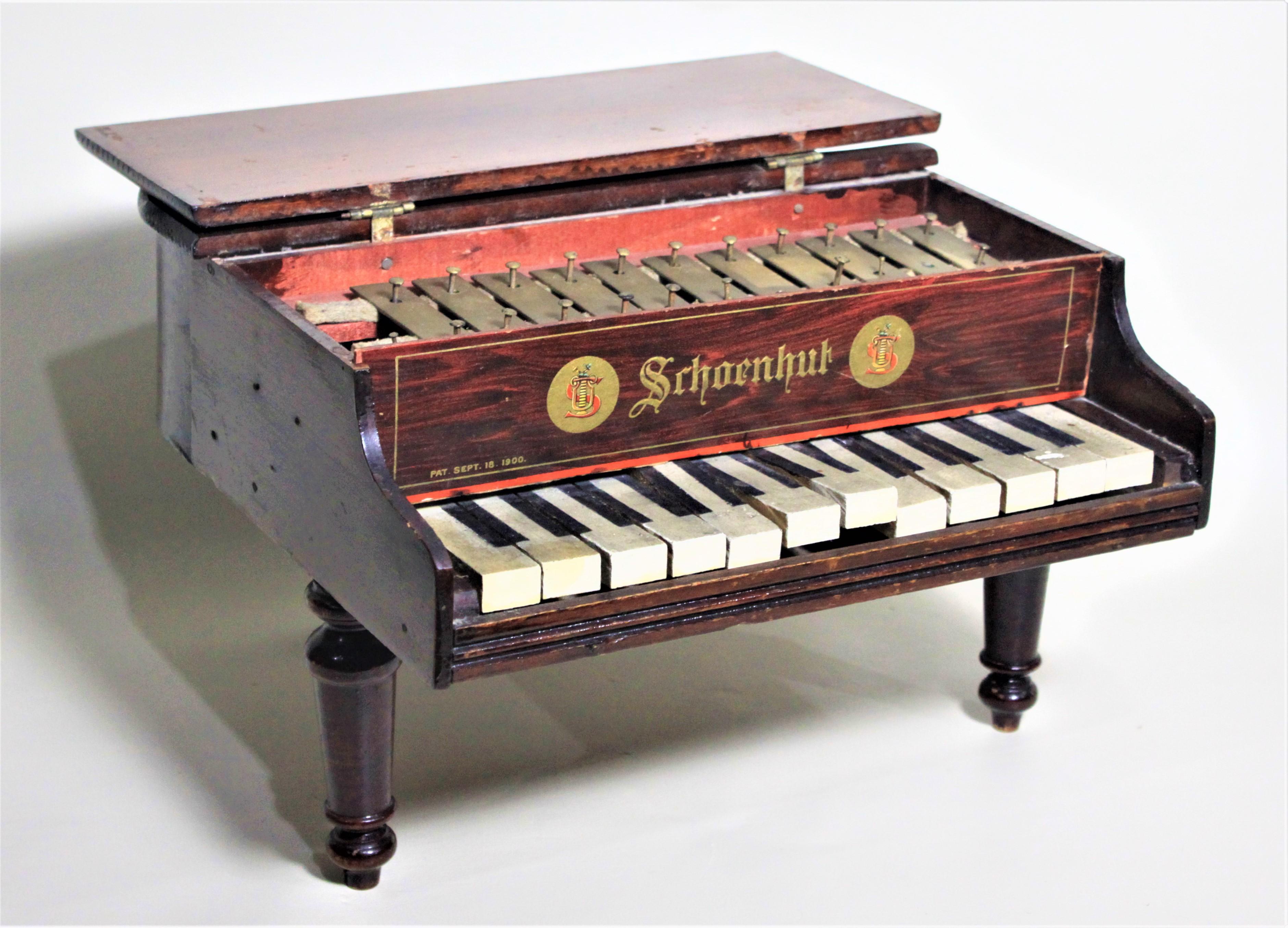 Made by the renowned American toy manufacturer in approximately 1920, this wooden toy baby grand piano has been autographed in two places by the legendary Liberace. The piano shows one signature on the bottom which is dated May 1954 or 1955 as the