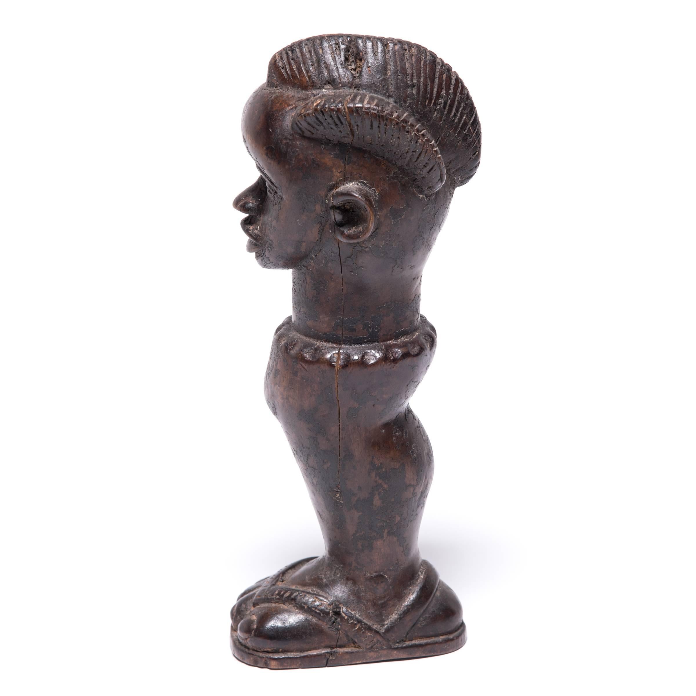Showcasing the smooth, restrained sculptural style of the Dan people of Western Africa, this fetish figure from the early 20th century would have been called upon to bring good luck, keep away evil spirits, or connect with ancestors. Imbued with