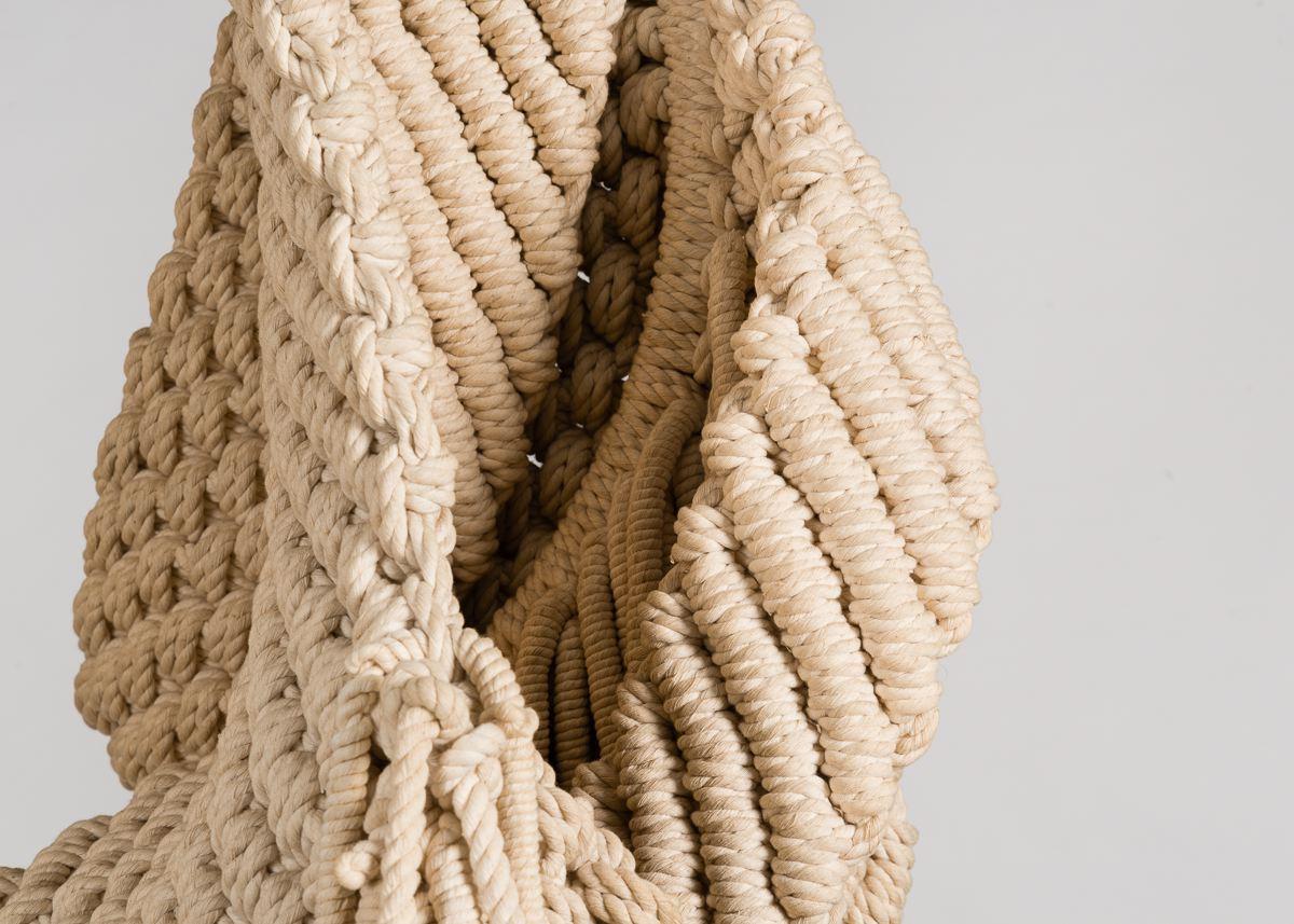 Set apart from traditional wall hangings and tapestries, this work by Liberta Wilms is defined by volume. With cascading layers of woven cotton, the piece unfolds before the viewer. While the circular frame
provides structure near the top, a more