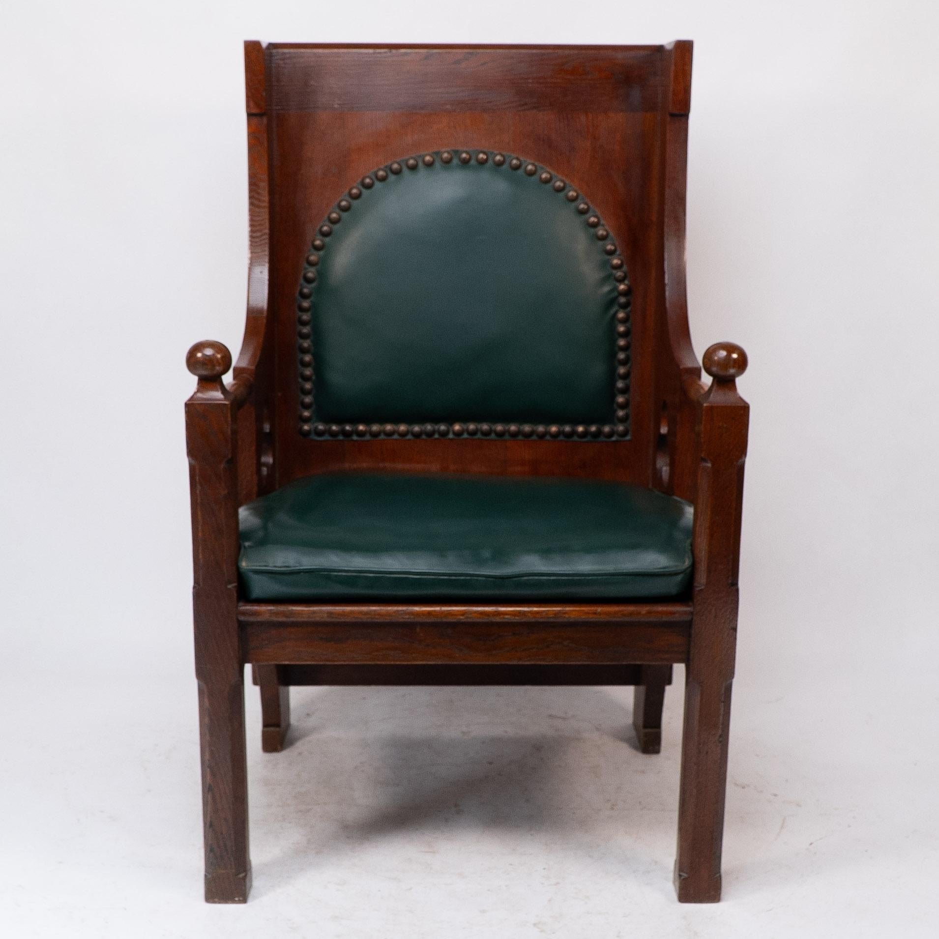 Liberty and Co. A good quality Arts and Crafts oak armchair, with original Liberty label to the underneath.