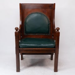 Liberty and Co. A good quality Arts and Crafts oak armchair with leather cushion