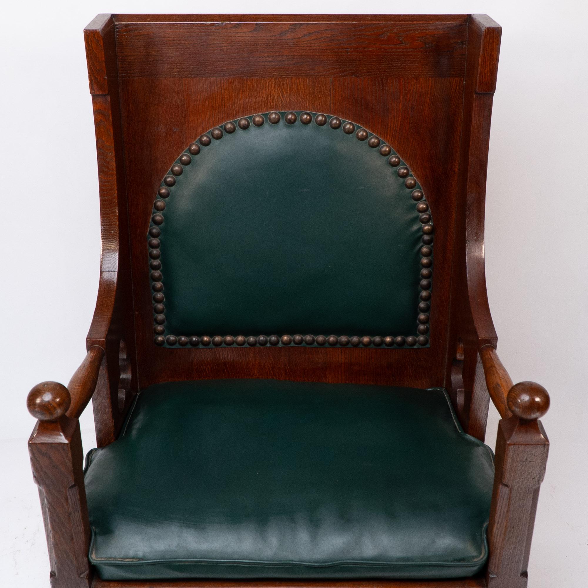 Oak Liberty and Co. A good quality Arts and Crafts oak armchair with leather cushion For Sale