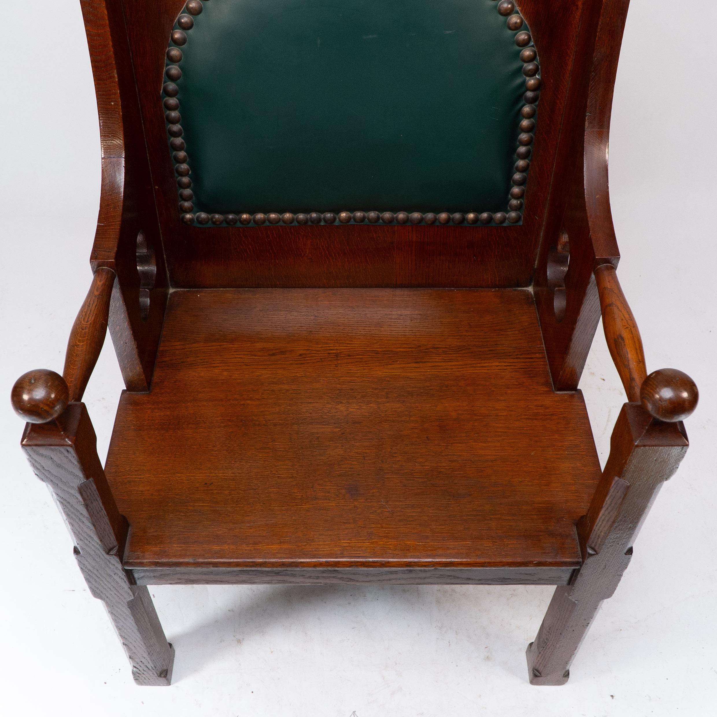 Liberty and Co. A good quality Arts and Crafts oak armchair with leather cushion For Sale 1