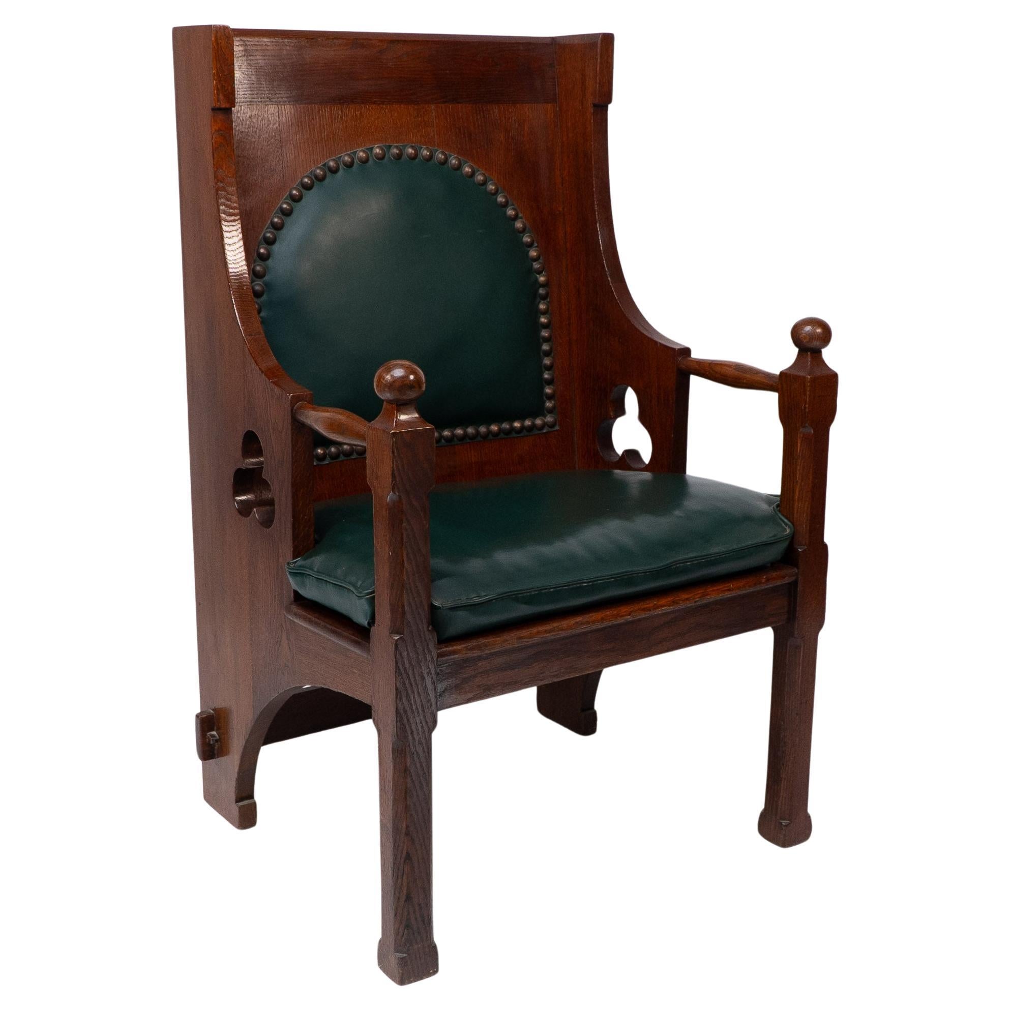 Liberty and Co. A good quality Arts and Crafts oak armchair with leather cushion For Sale