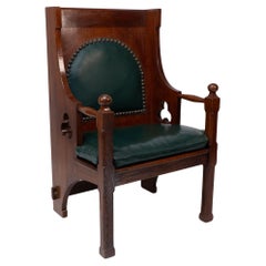 Antique Liberty and Co. A good quality Arts and Crafts oak armchair with leather cushion