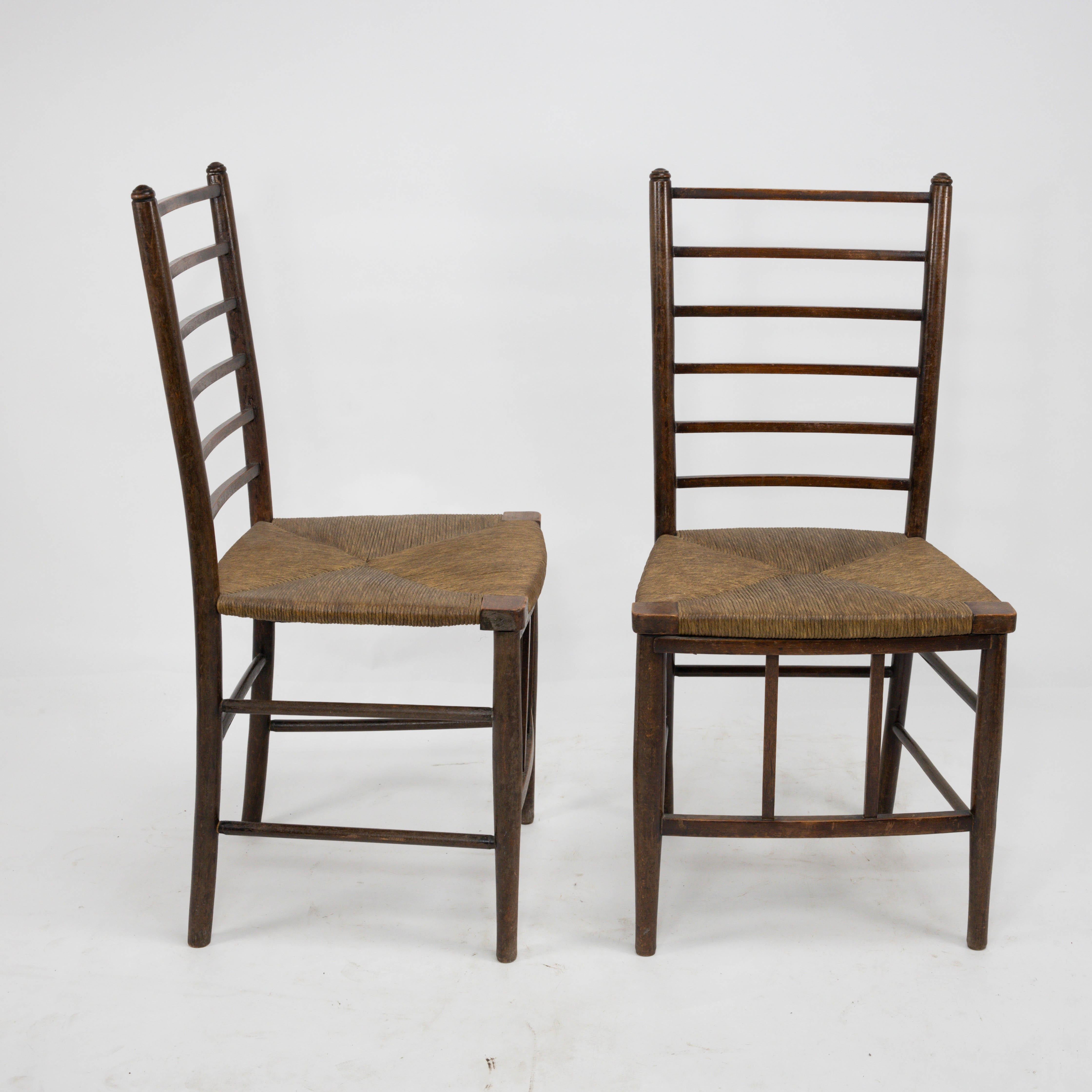 Liberty and Co, a pair of Arts & Crafts ladder back side chairs with the original finely laid rushed seats and stylish simple upright details to the fronts, uniting the front stretcher.
I also have a taller version of these available separately.