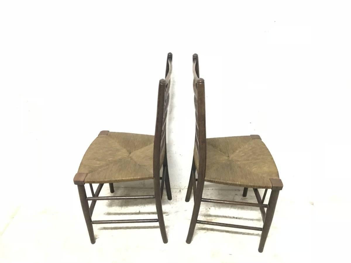 English Liberty and Co, A Pair of Arts and Crafts Side Chairs with Finely Rushed Seats For Sale