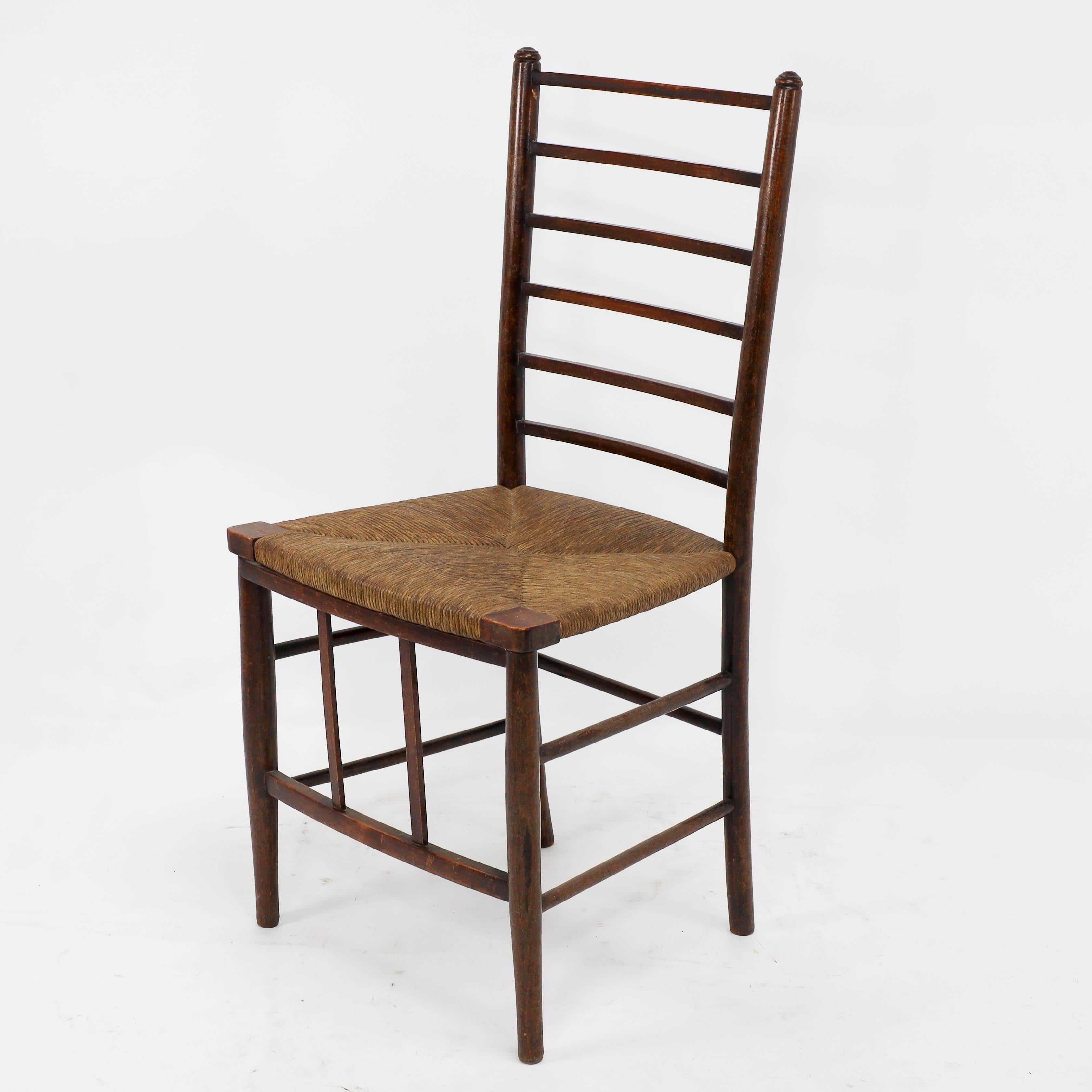 English Liberty and Co, A pair of Arts and Crafts side chairs with finely rushed seats For Sale