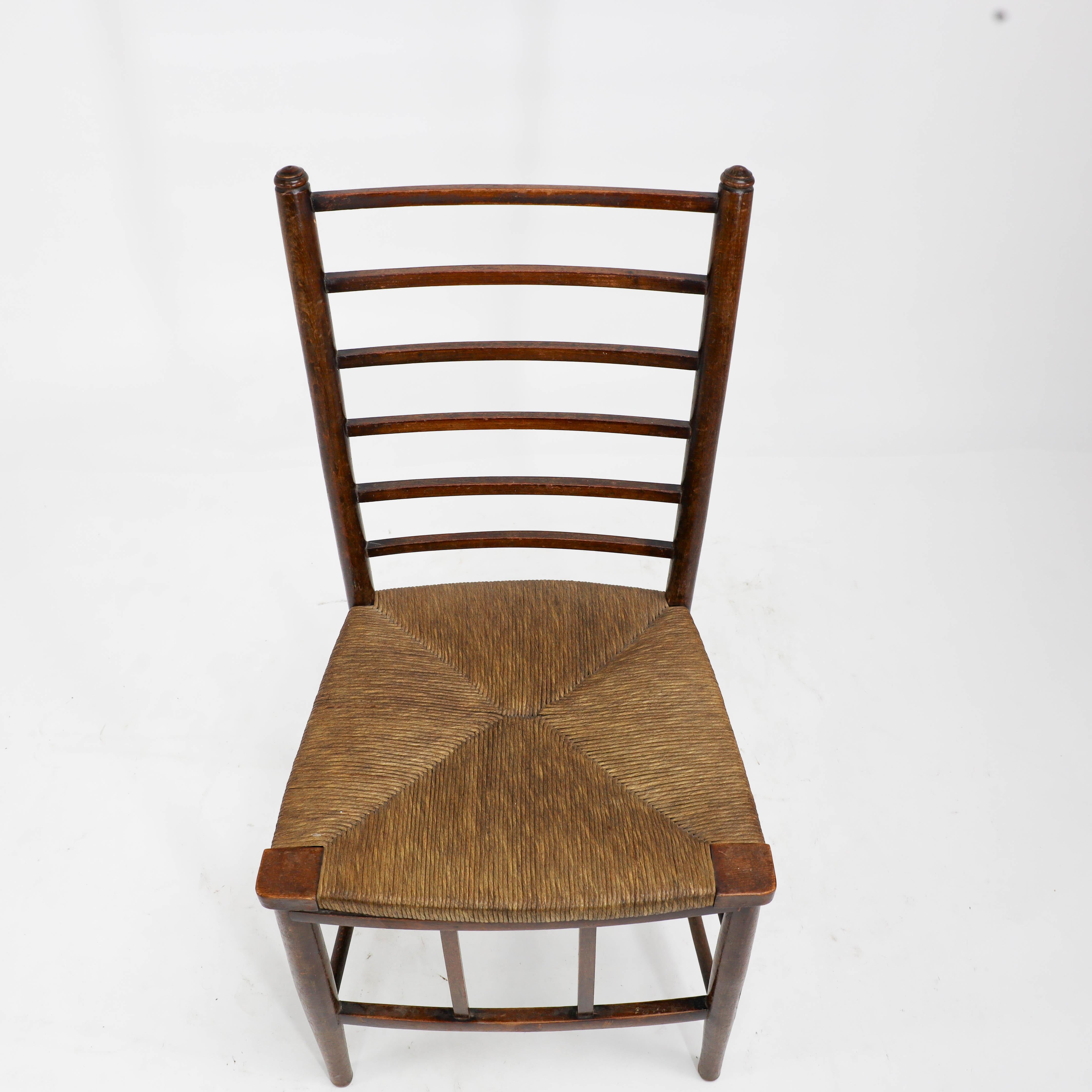 Early 20th Century Liberty and Co, A pair of Arts and Crafts side chairs with finely rushed seats For Sale