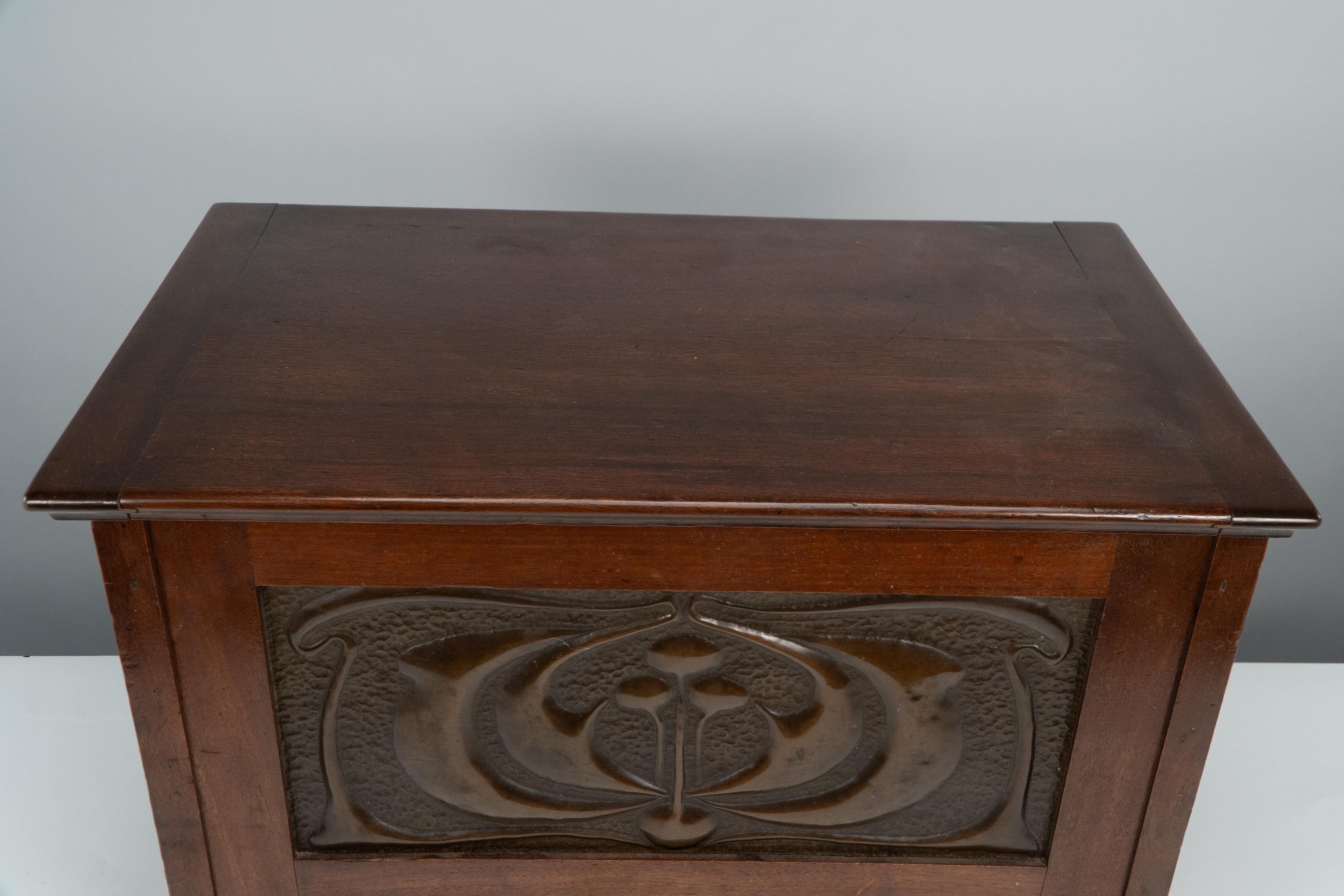 Mahogany Liberty and Co. A small trunk with copper panels in the style of C R Mackintosh. For Sale