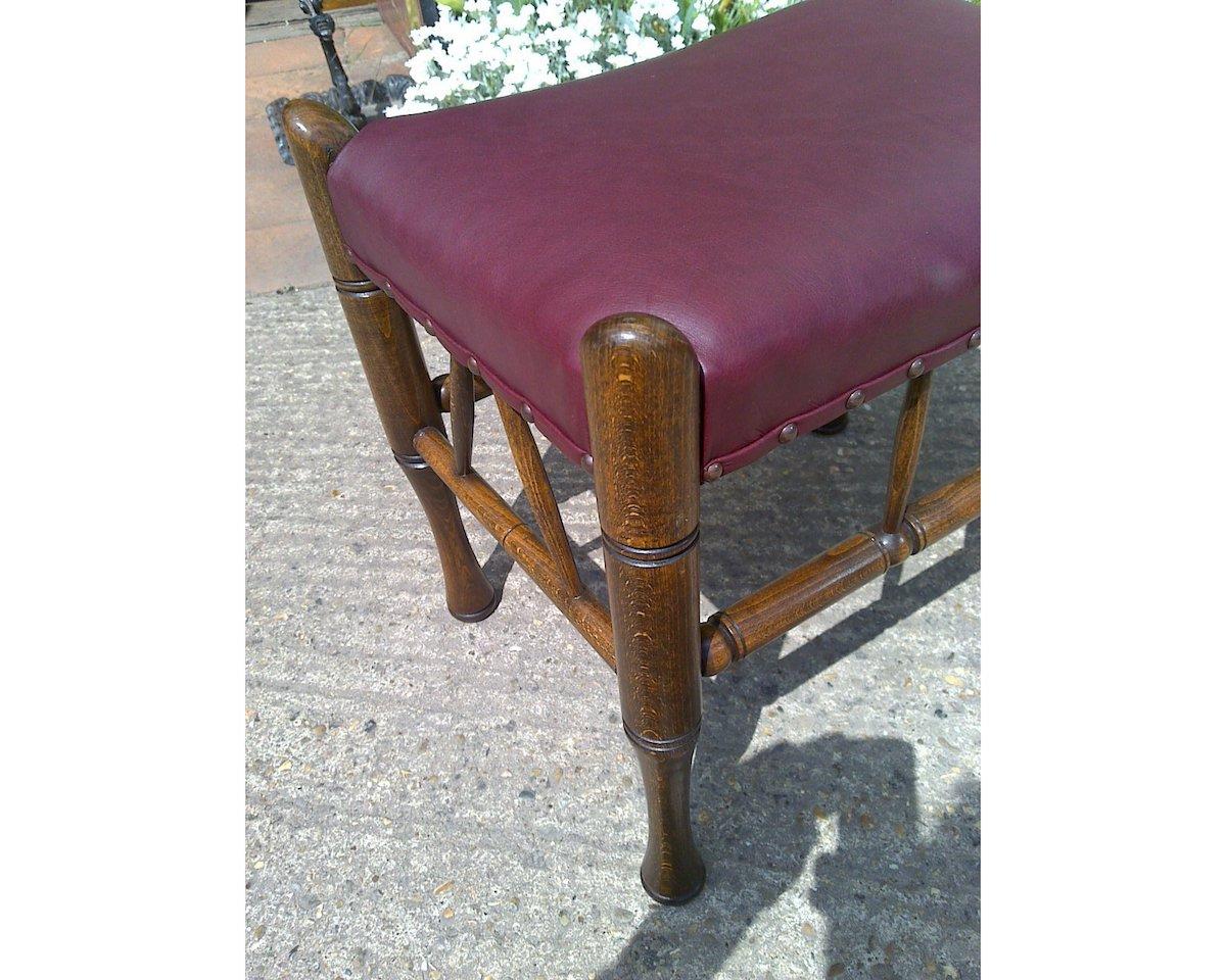 Arts and Crafts Liberty and Co. A Stained Beech and Leather Thebes Stool. For Sale