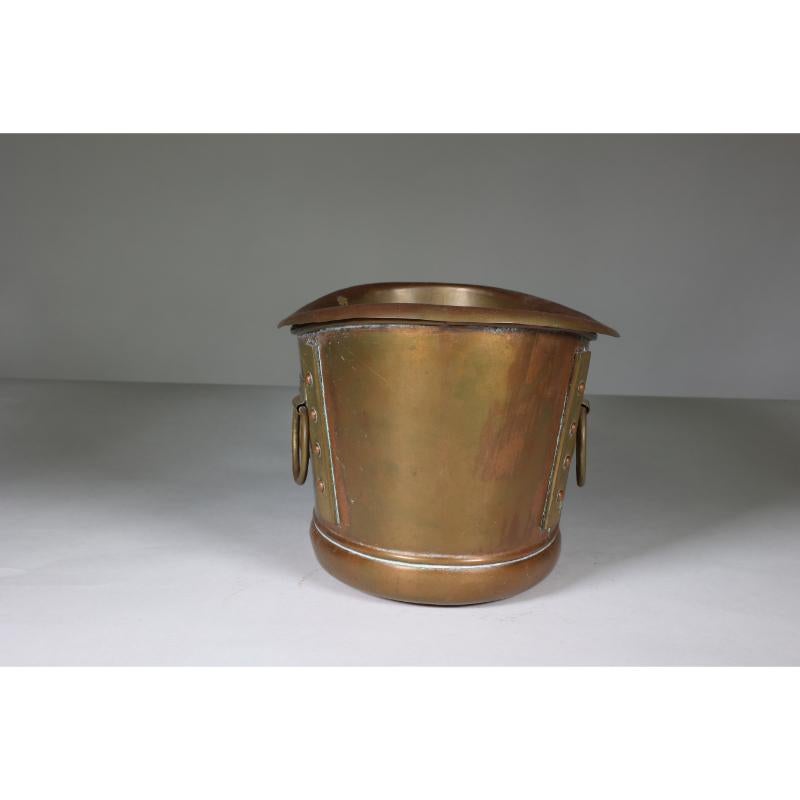 Liberty and Co. A brass Arts and Crafts boat-shaped champagne bucket with a removable liner. Stamped Wood & Co, Liberty & Co and 3847.
