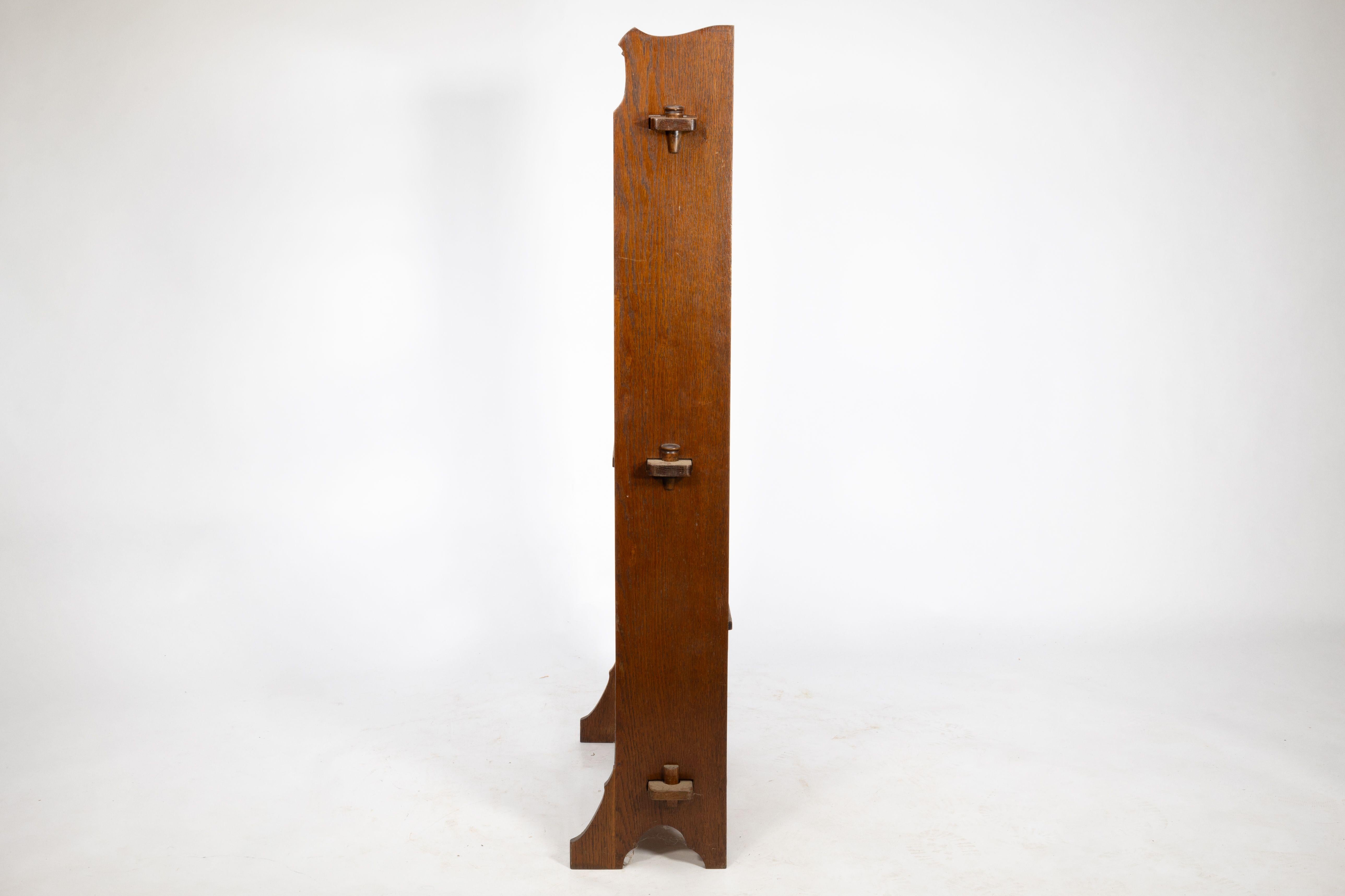 Early 20th Century Liberty and Co. An Arts and Crafts golden oak bookcase flat packed For Sale