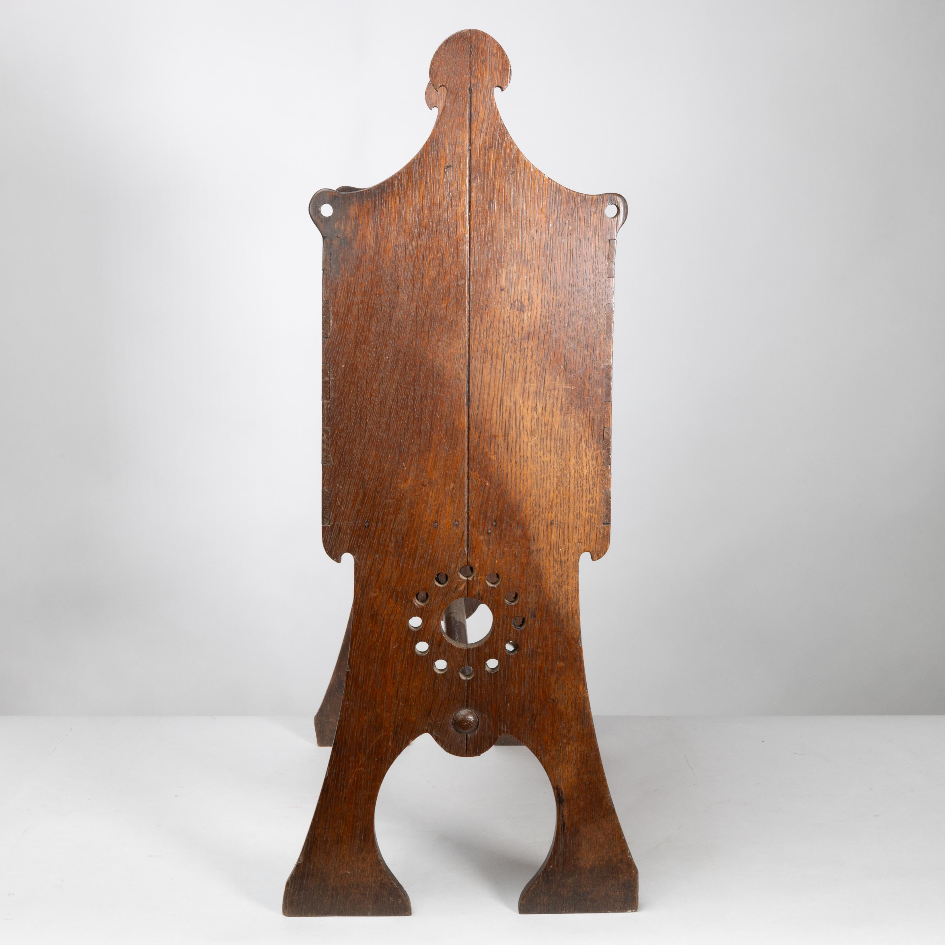 English Liberty and Co. An Arts and Crafts oak magazine rack For Sale