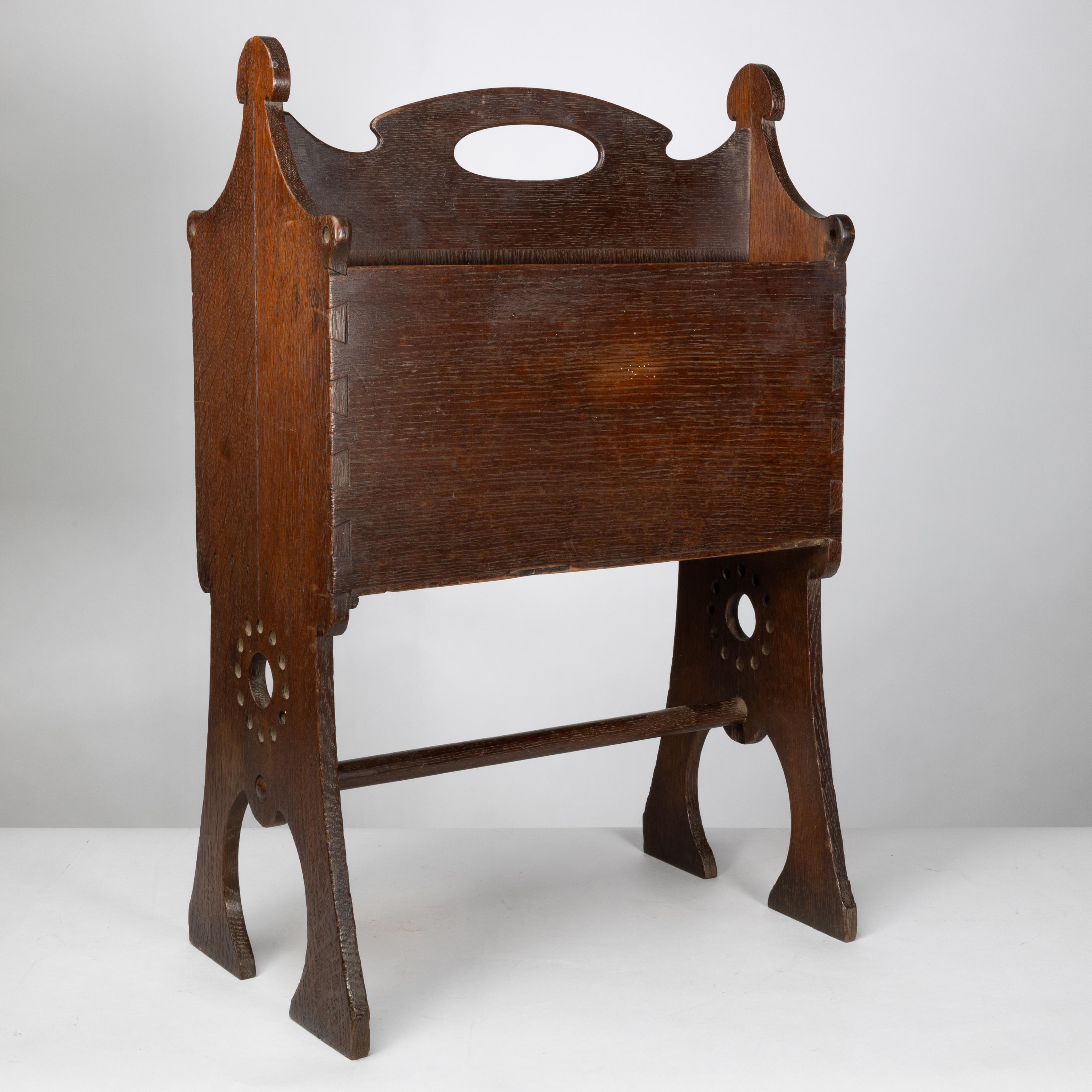Oak Liberty and Co. An Arts and Crafts oak magazine rack For Sale