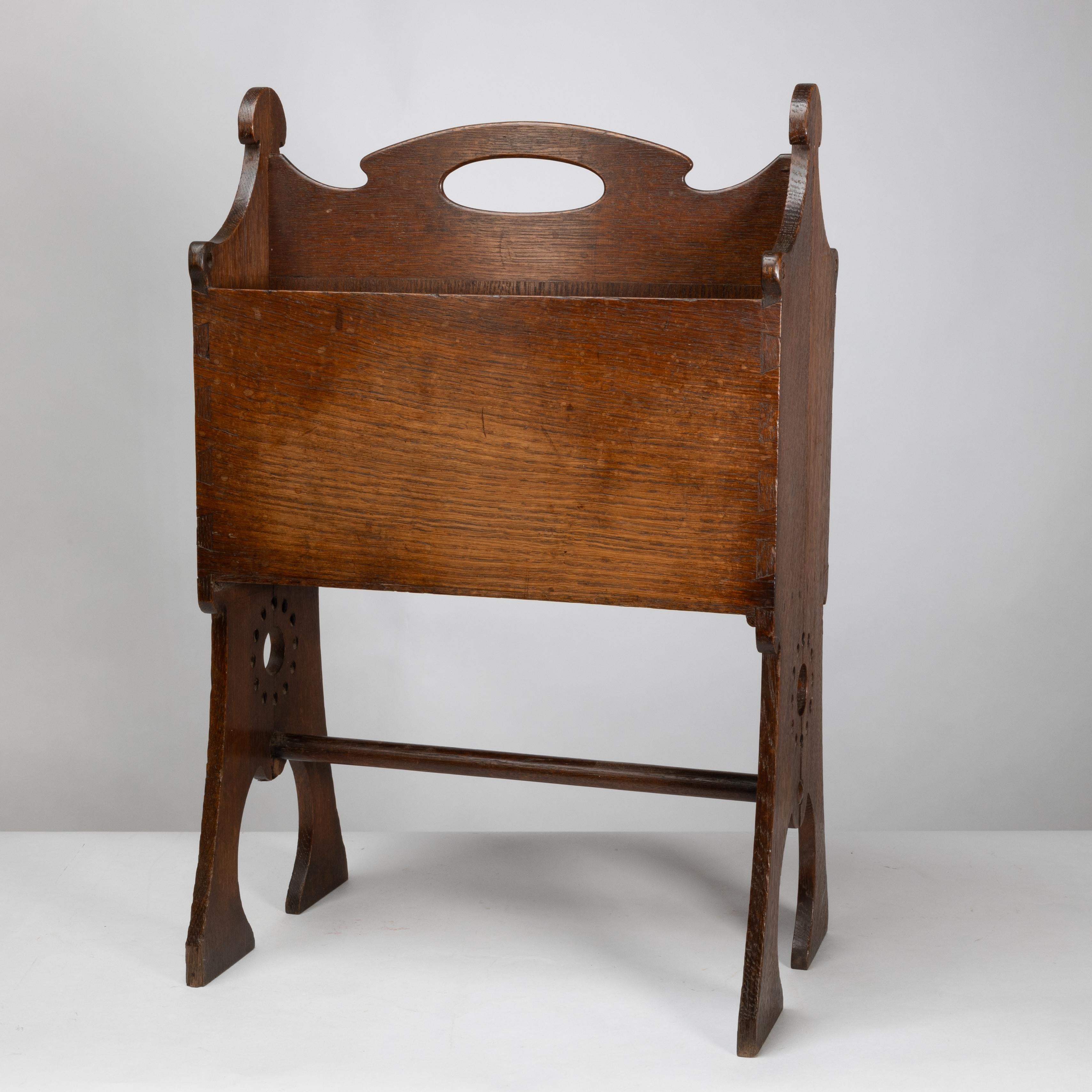 Liberty and Co. An Arts and Crafts oak magazine rack For Sale 1