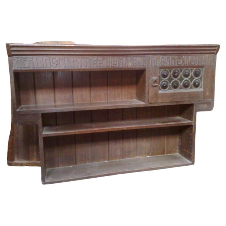 Liberty and Co. An Arts and Crafts oak over mantle or hanging bookshelf