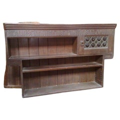 Liberty and Co. An Arts and Crafts oak over mantle or hanging bookshelf