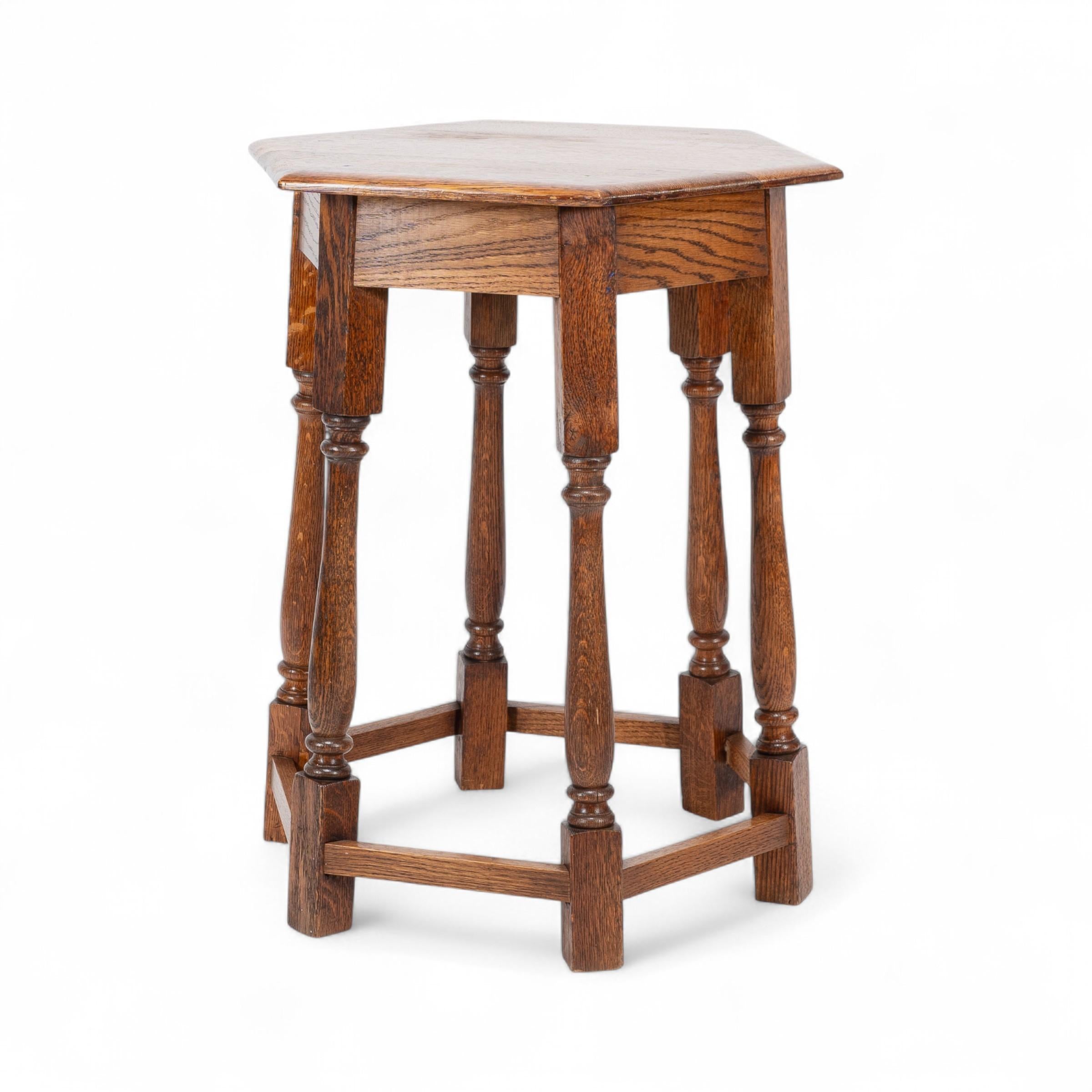 Oak Liberty and Co. An Arts and Crafts oak side table with a hexagonal top For Sale